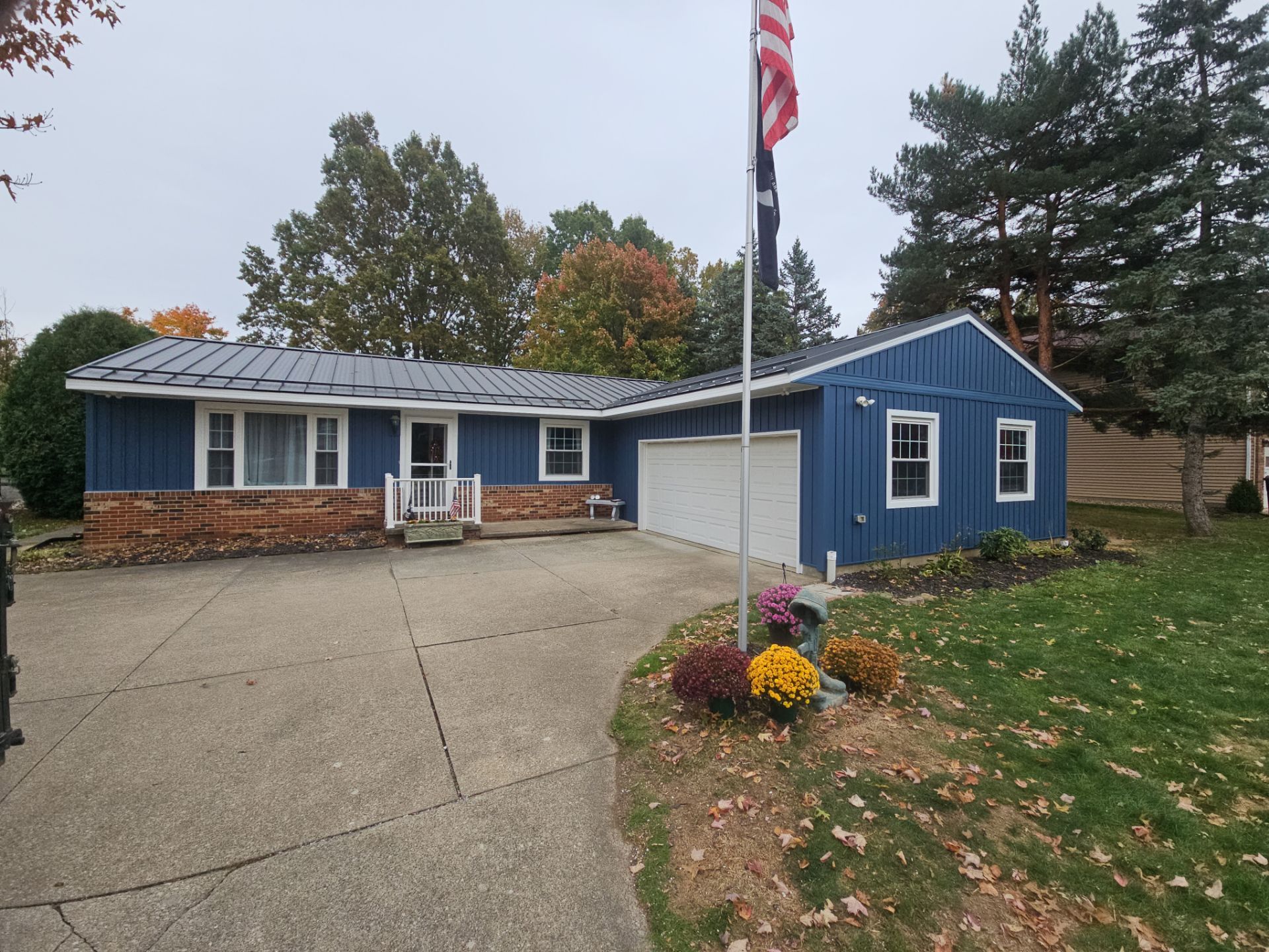 Wadsworth Exterior Transformation Featuring Blue Vertical Siding and Metal Roofing by Cornerstone Roofing And Siding