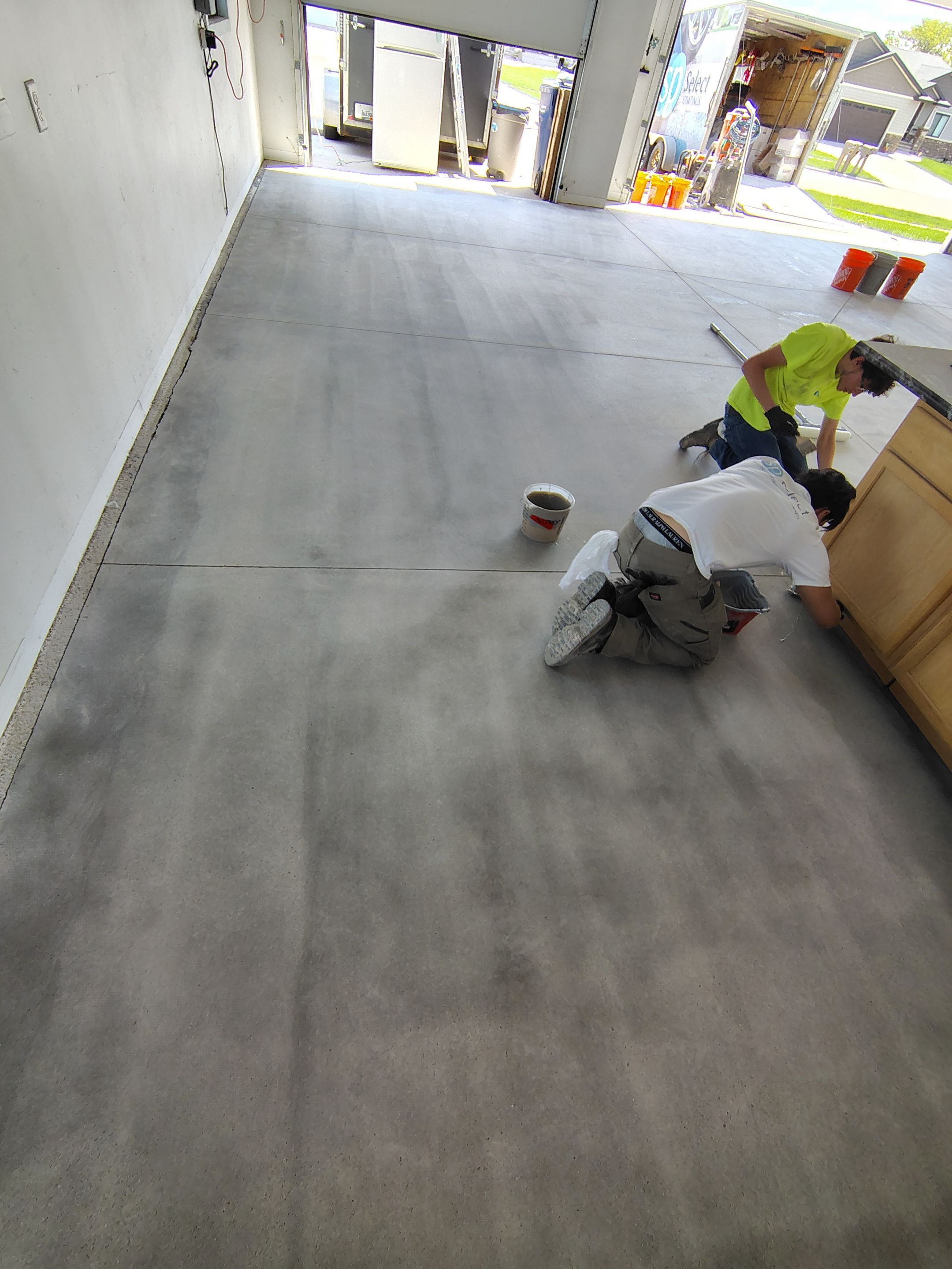 Speckled Polyaspartic Garage Floor Coating Installation in Dell Rapids by Select Painting, Coatings & Garage Cabinets