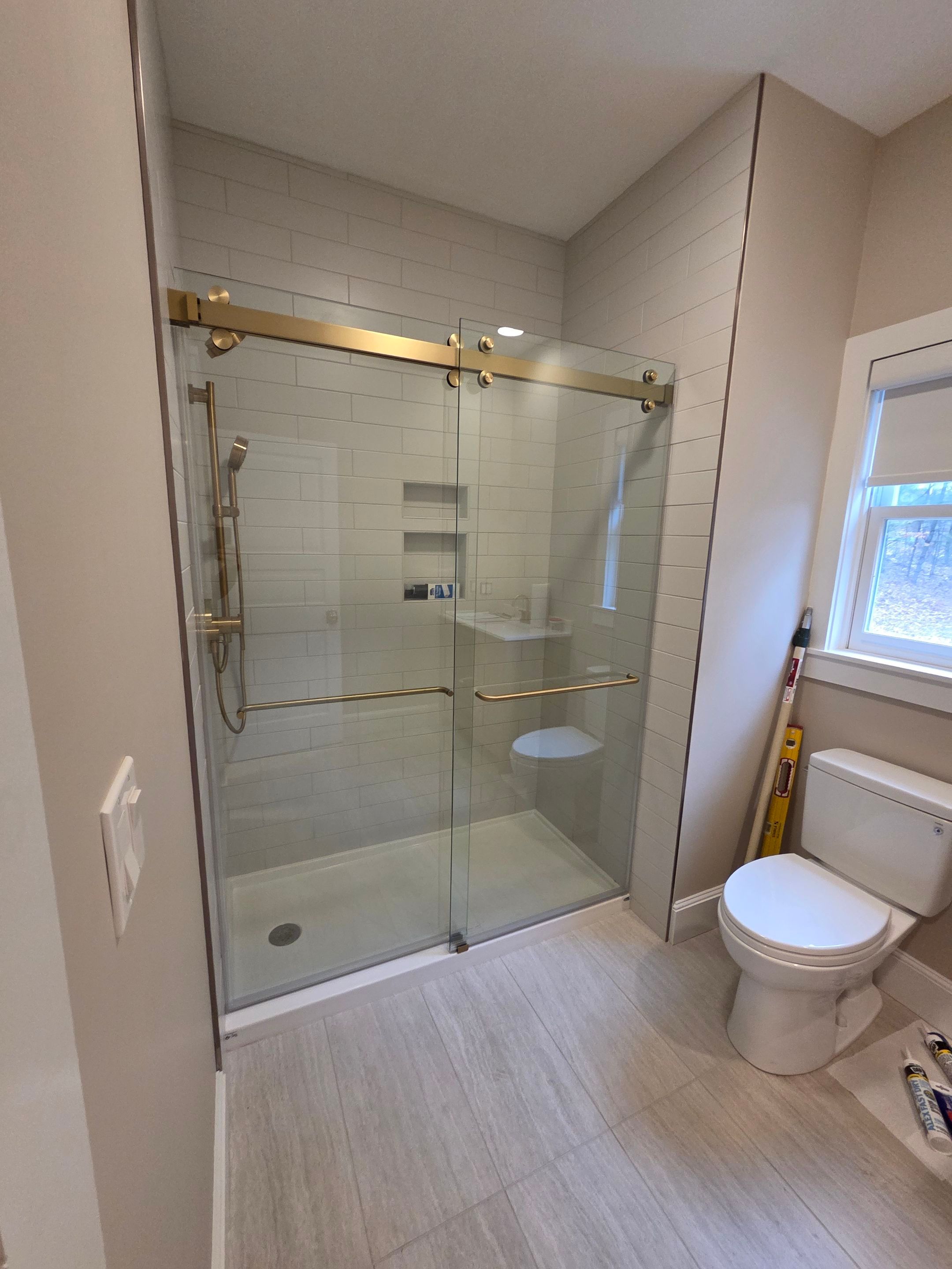 CRL Cambridge Series Dual Sliding Shower Enclosure — Installed in 3/8" Clear ShowerGuard Glass with Brushed Bronze Accents by Cheshire Glass Company