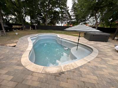 Freeform Pool with Raised Spa and Natural Stone Deck
