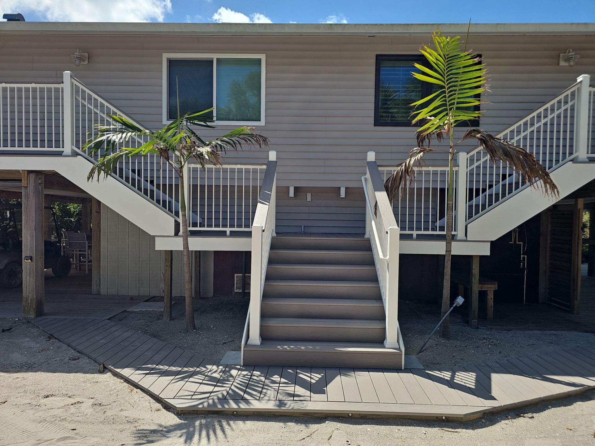 Elevated Home Deck Reconstruction With White Aluminum Railings in Placida by Smirnov Construction Inc
