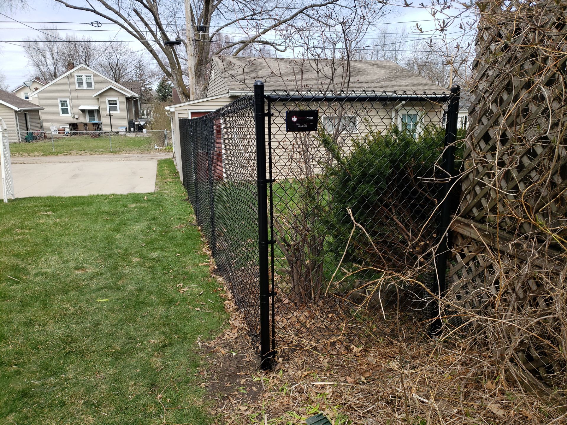 Black Vinyl Coated Chain Link Fence Installation in Waterloo by Perfect Picket Fence and Stain