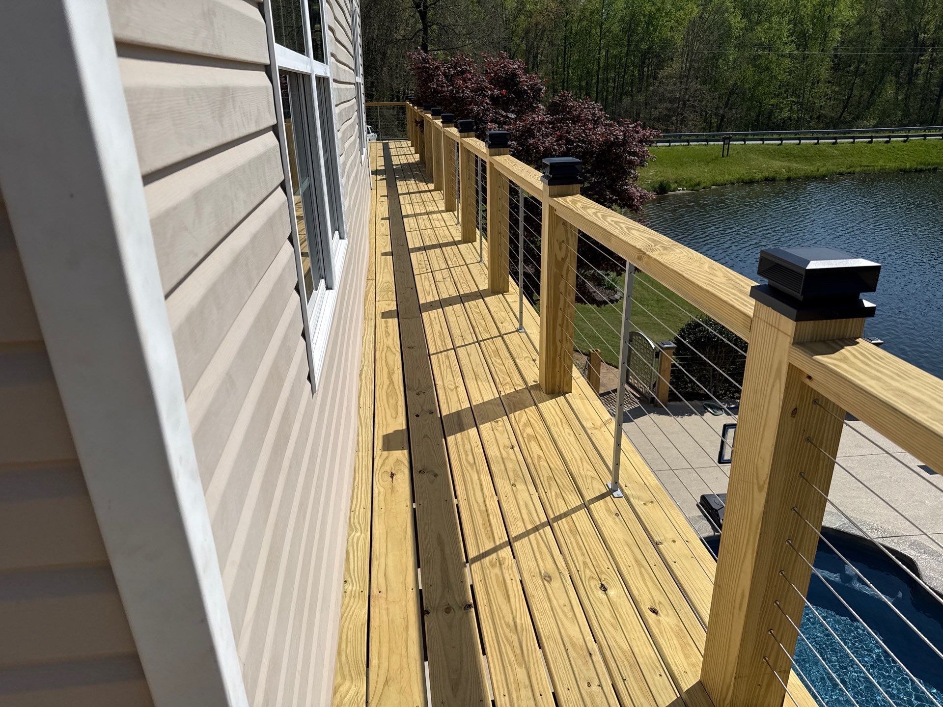 Cumming, GA Lake House Deck Resurface and Extension using Pressure Treated Pine and Skyline Cable Railing by Nelson Exteriors 