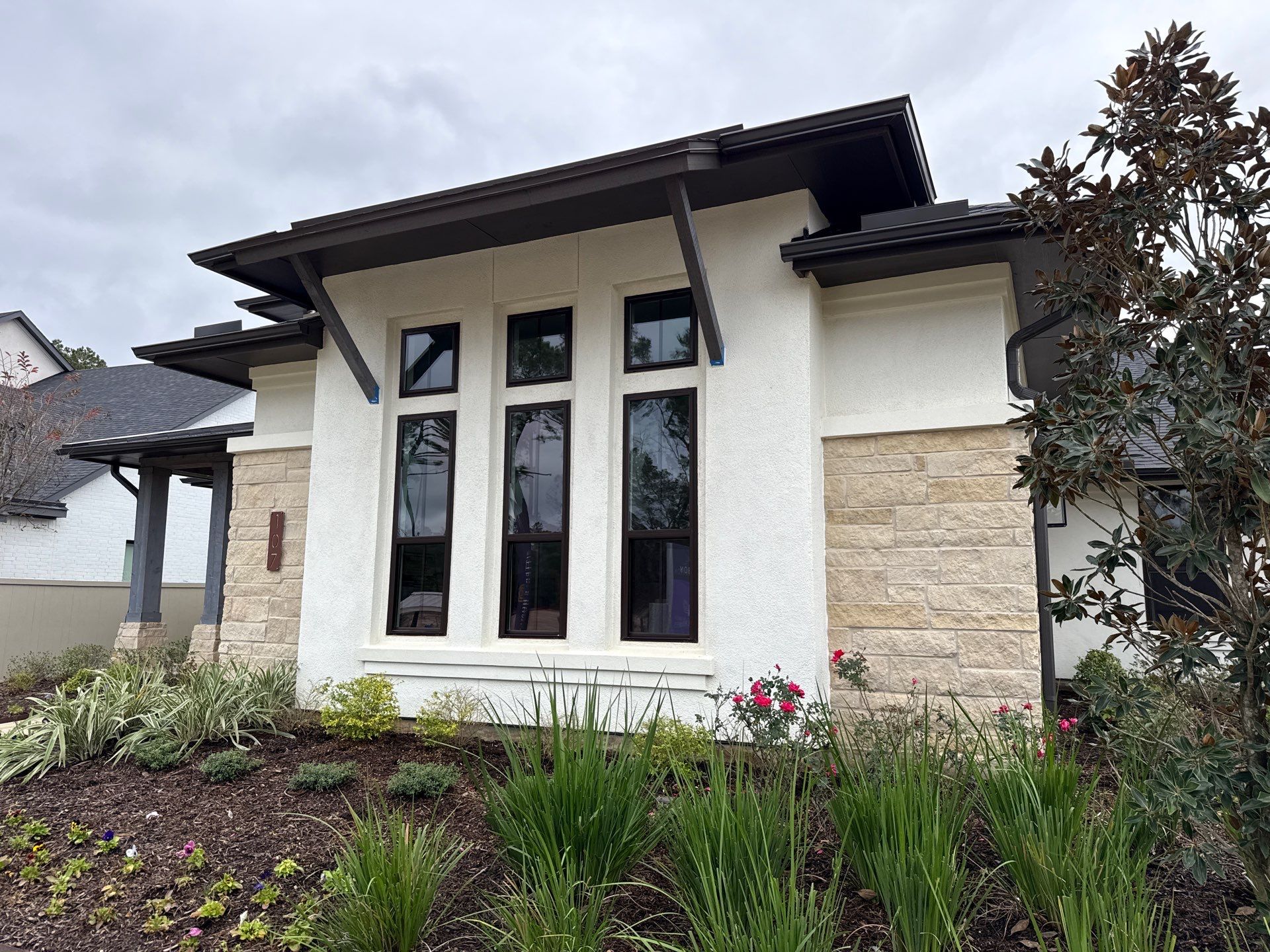 Magnolia Contrast: Light Stucco with Dark Accents and Stone Details by Apex Conventional Stucco Llc