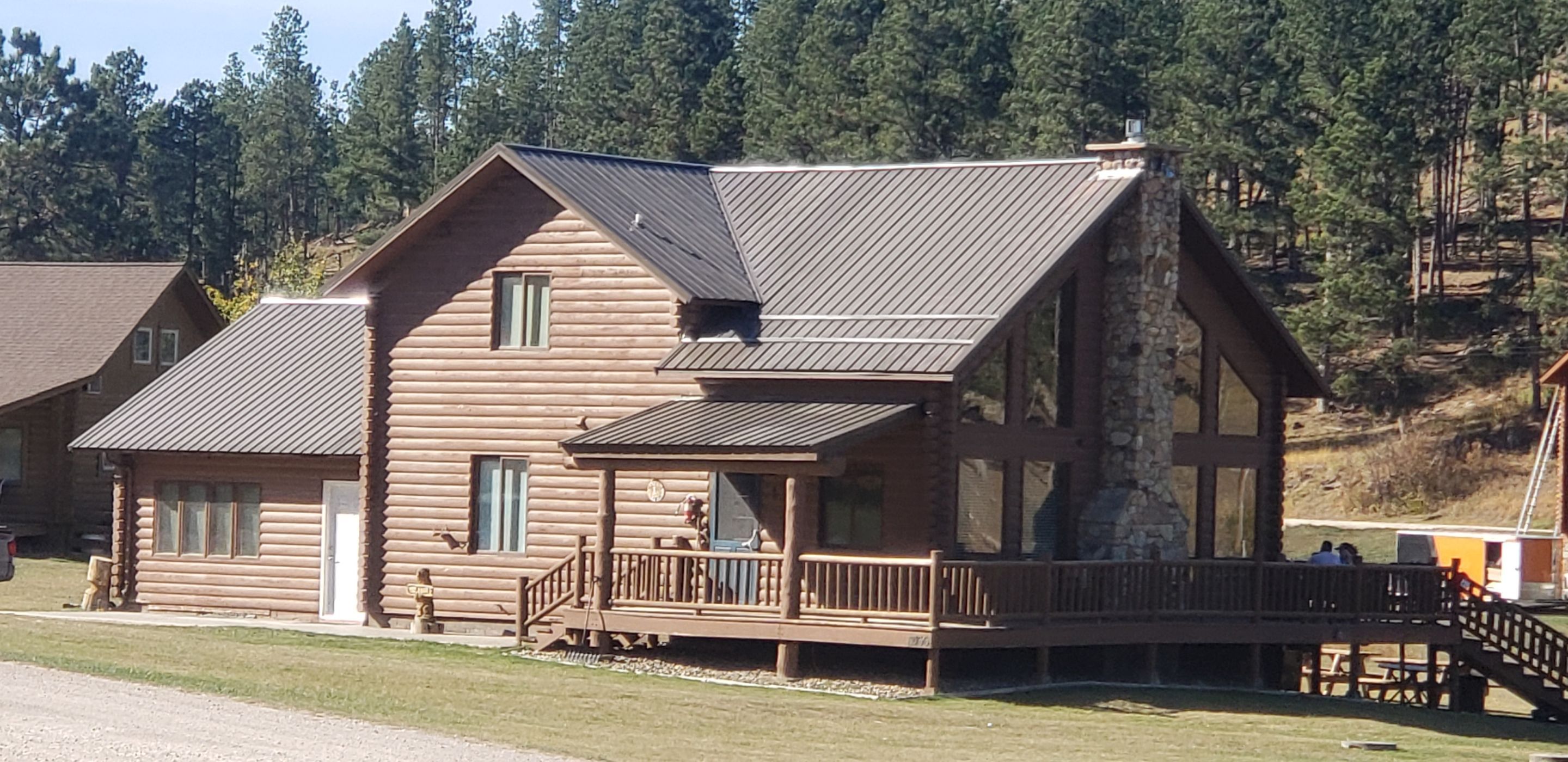 Hill Country Guest Ranch using Steel Roofing, Gutters, Log Cabin Staining by Lightning Exteriors