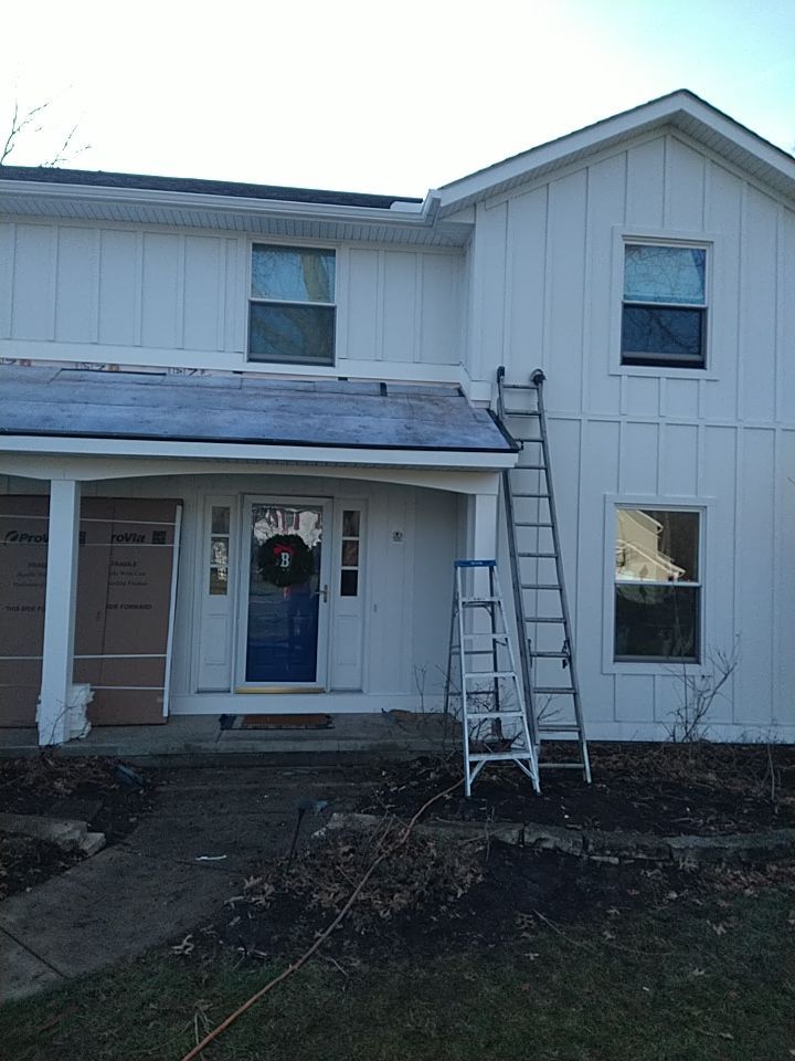 James Hardie Siding  using James Hardie Board and Batten, White by Absolute Roofing and Construction
