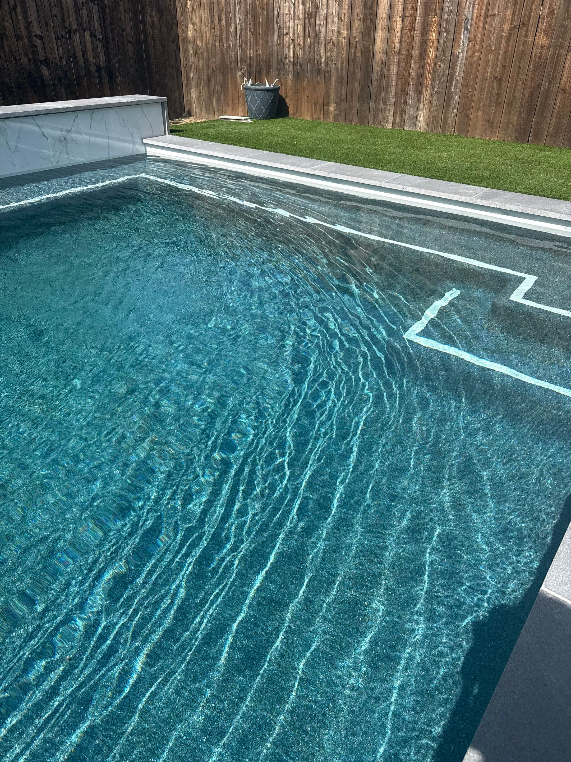 Modern Geometric Pool with Tanning Ledge and Turf by Pinnacle Pools and Spas - DFW
