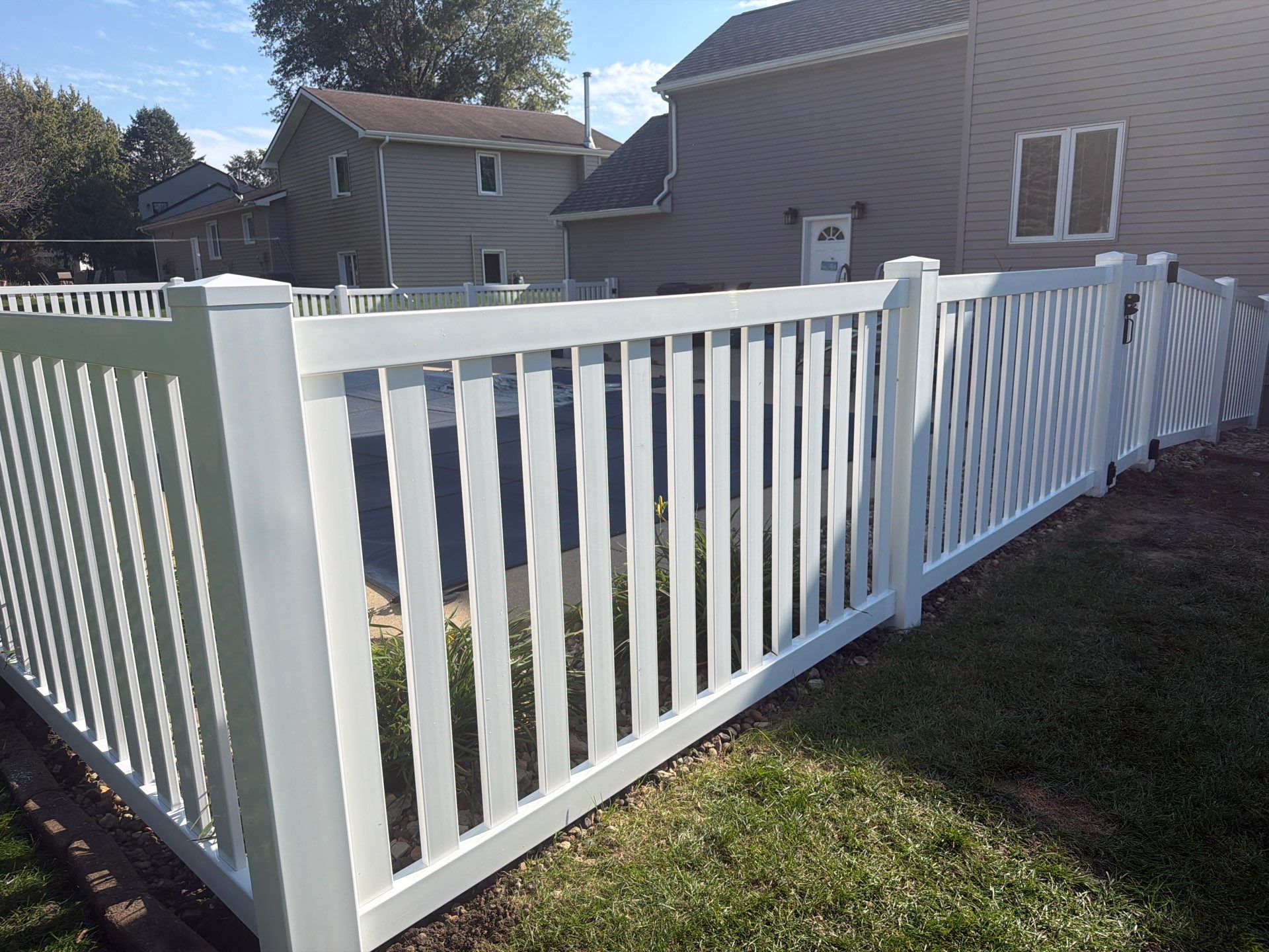 White Vinyl Picket Pool Fence Installation in Waterloo, Iowa by Perfect Picket Fence and Stain