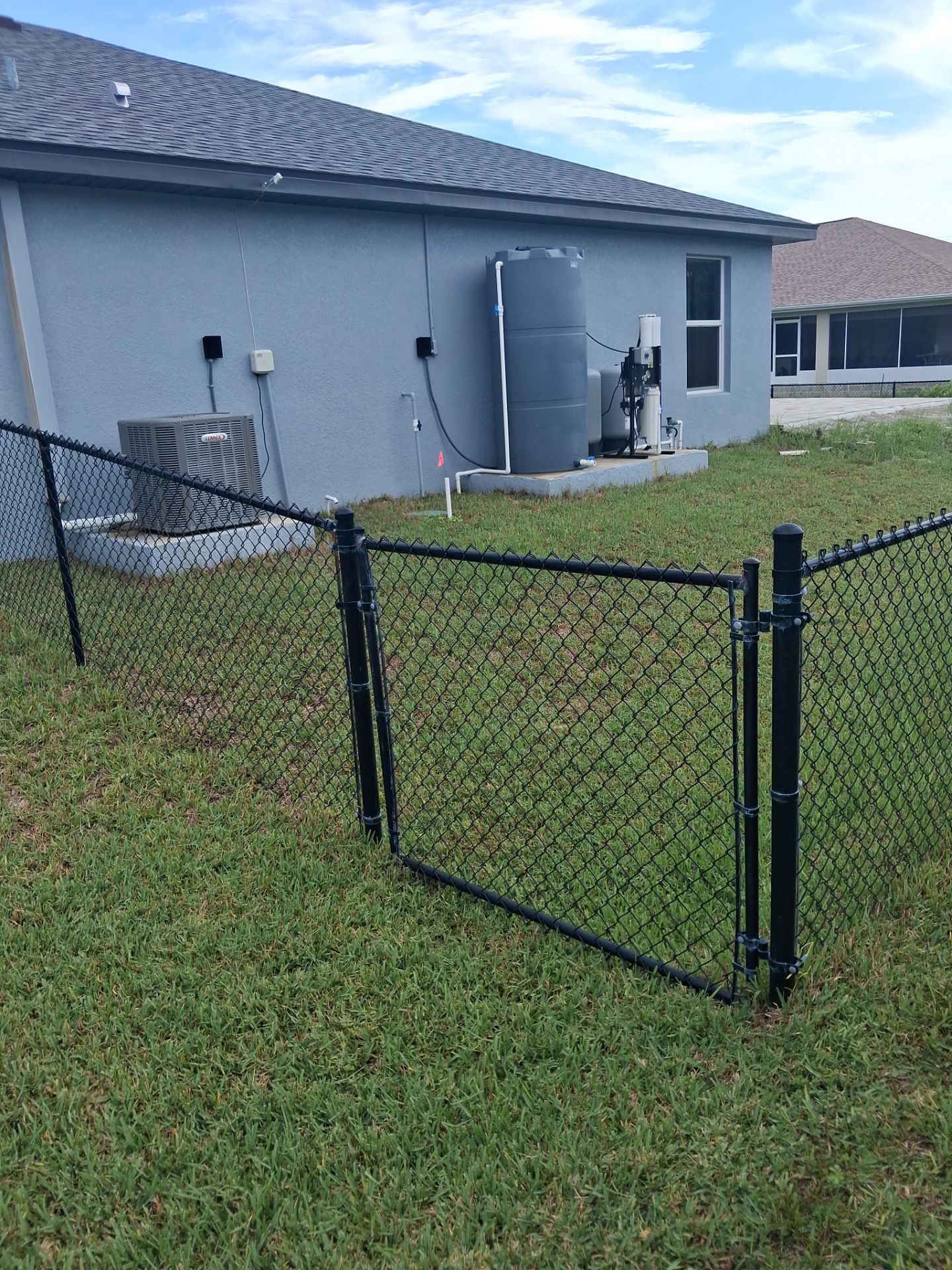 Residential Black Vinyl-Coated Chain Link Fence Installation in Port Charlotte by True Fence LLC