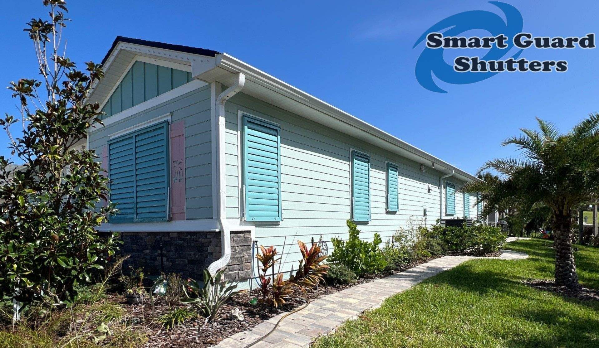 Impact Bahama Shutters in Pastel Turquoise by Smart Guard Shutters