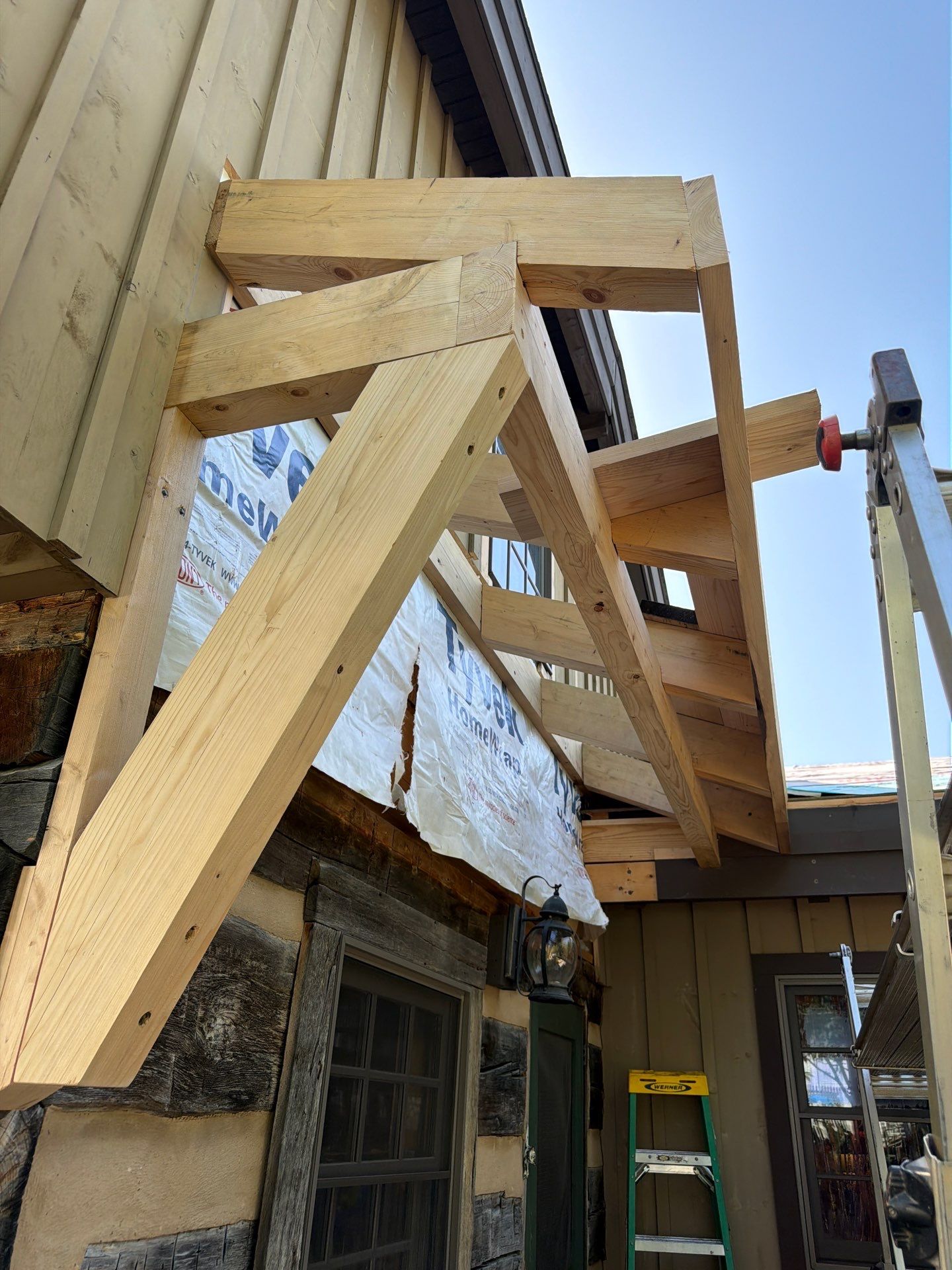 Custom Composite Deck with Stone Fireplace and Modern Cable Railing by Walnut Hollow Decks & Outdoor Living