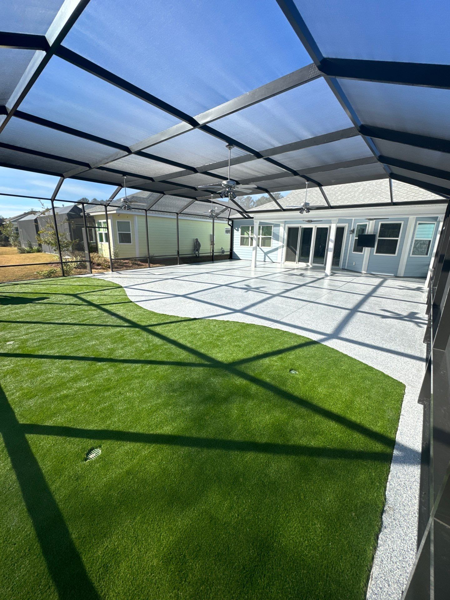 Hardeeville Screened-In Concrete Patio and Integrated Artificial Turf by Lowcountry Scapes, LLC