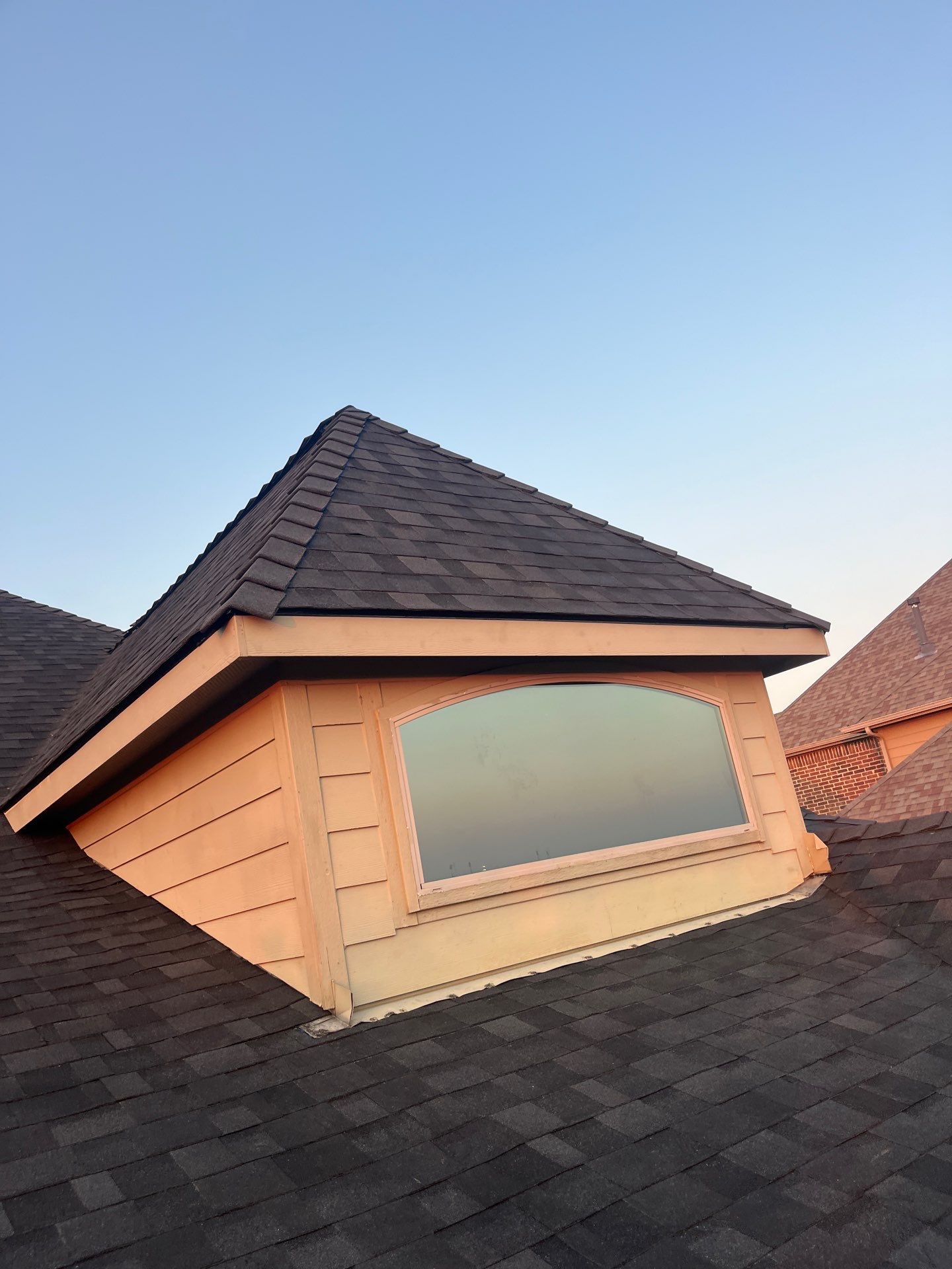 IKO Granite Black-Light Brown with dark brown sections brick house  by Tejas Roofworks + Restoration