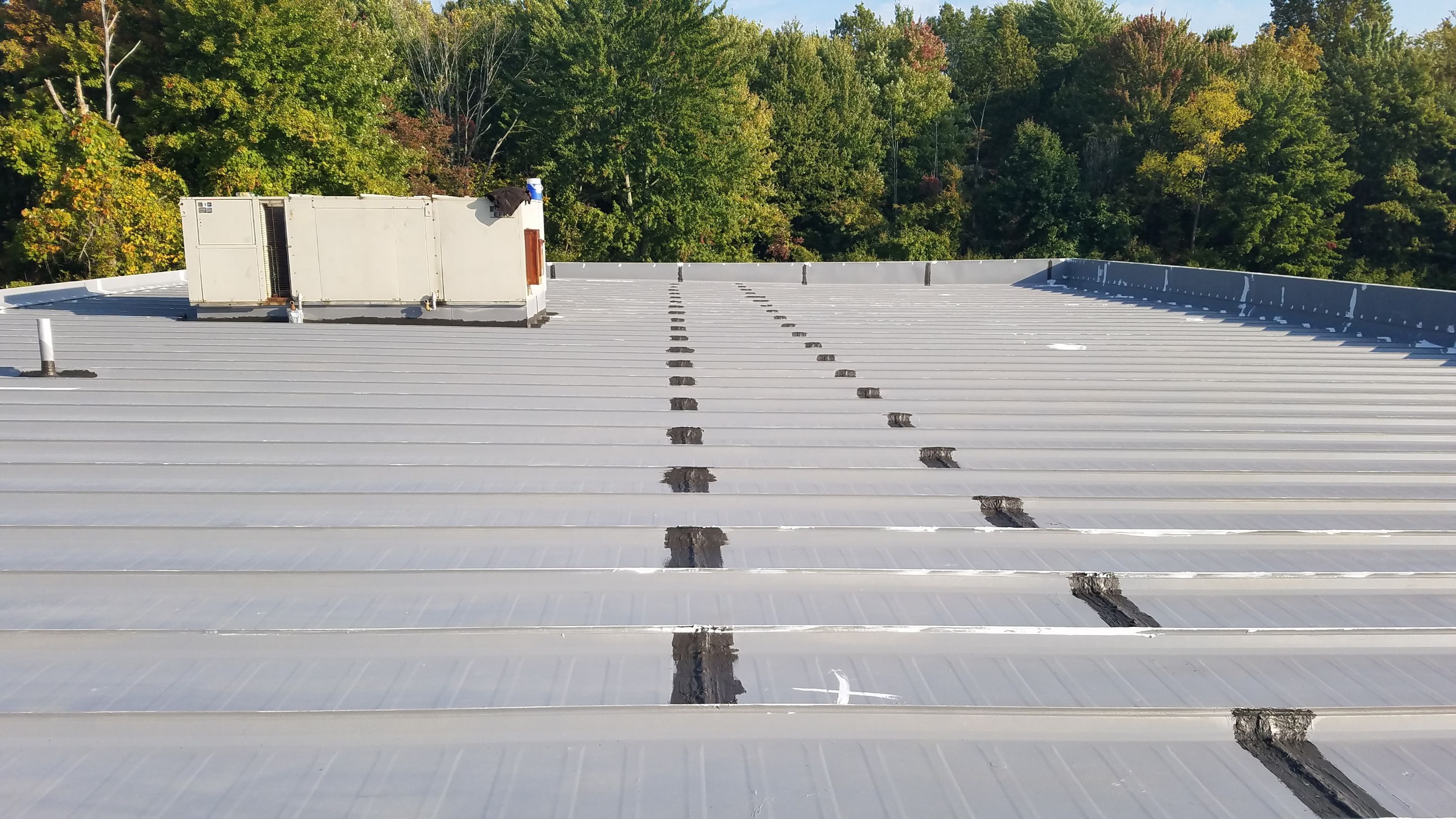 Commercial Metal Roof Coating by Gold Star Roofing LLC
