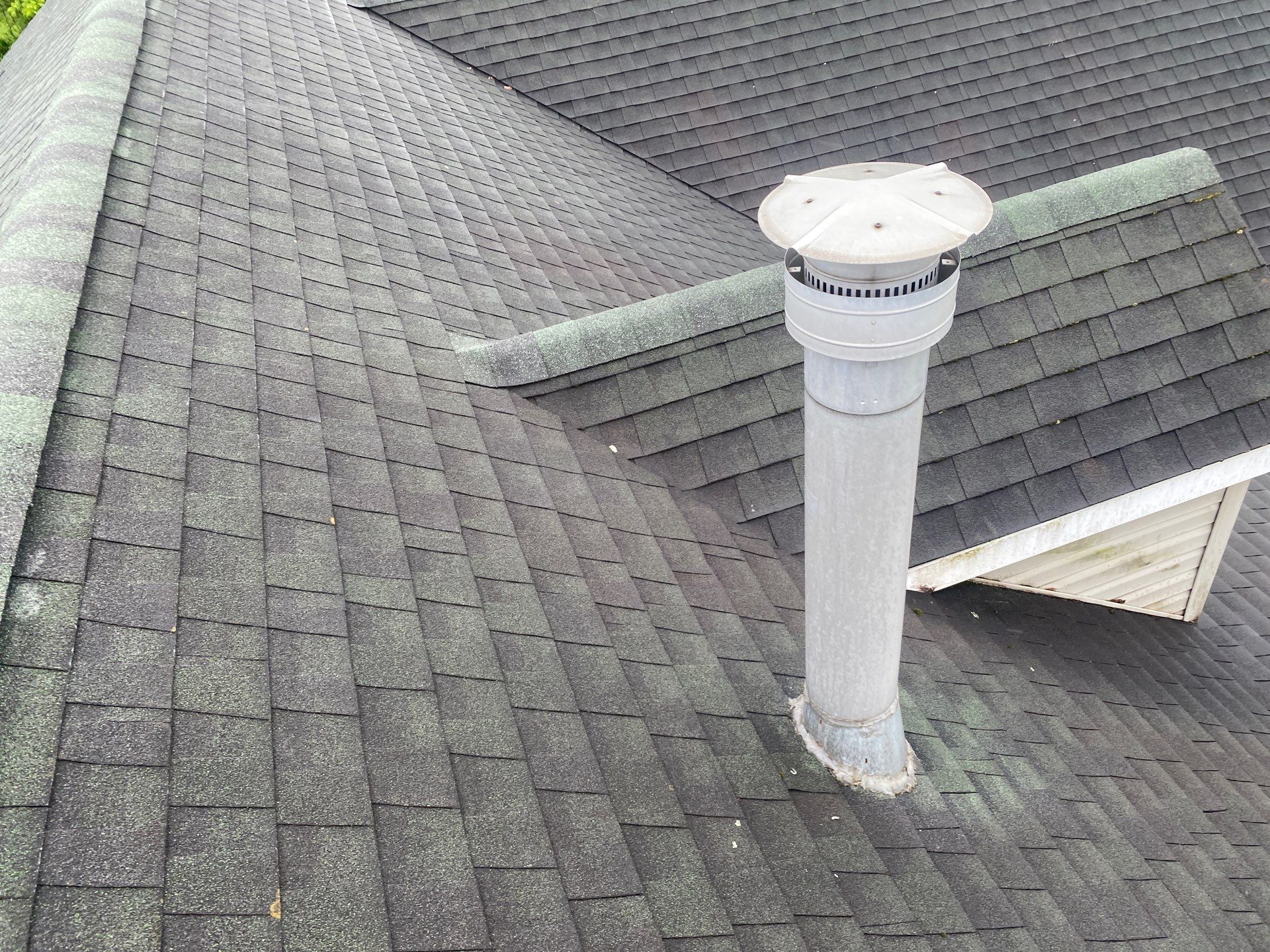 Green Metal Roof and Custom Covered Deck in Duncannon by Esh Builders