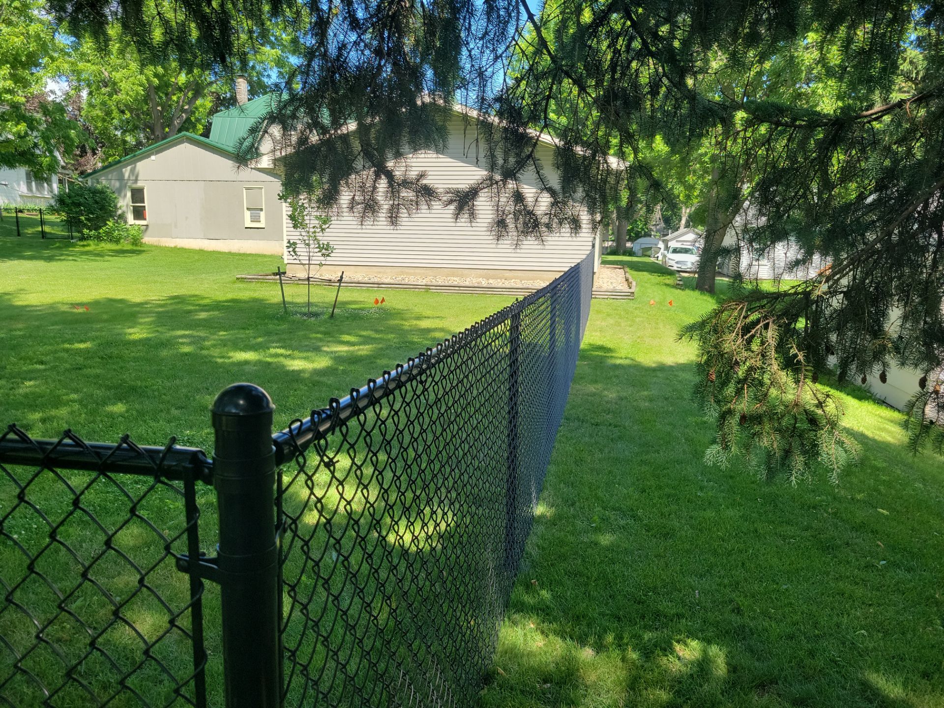 Black Chain Link Perimeter Fence and Driveway Gate in Waverly by Perfect Picket Fence and Stain