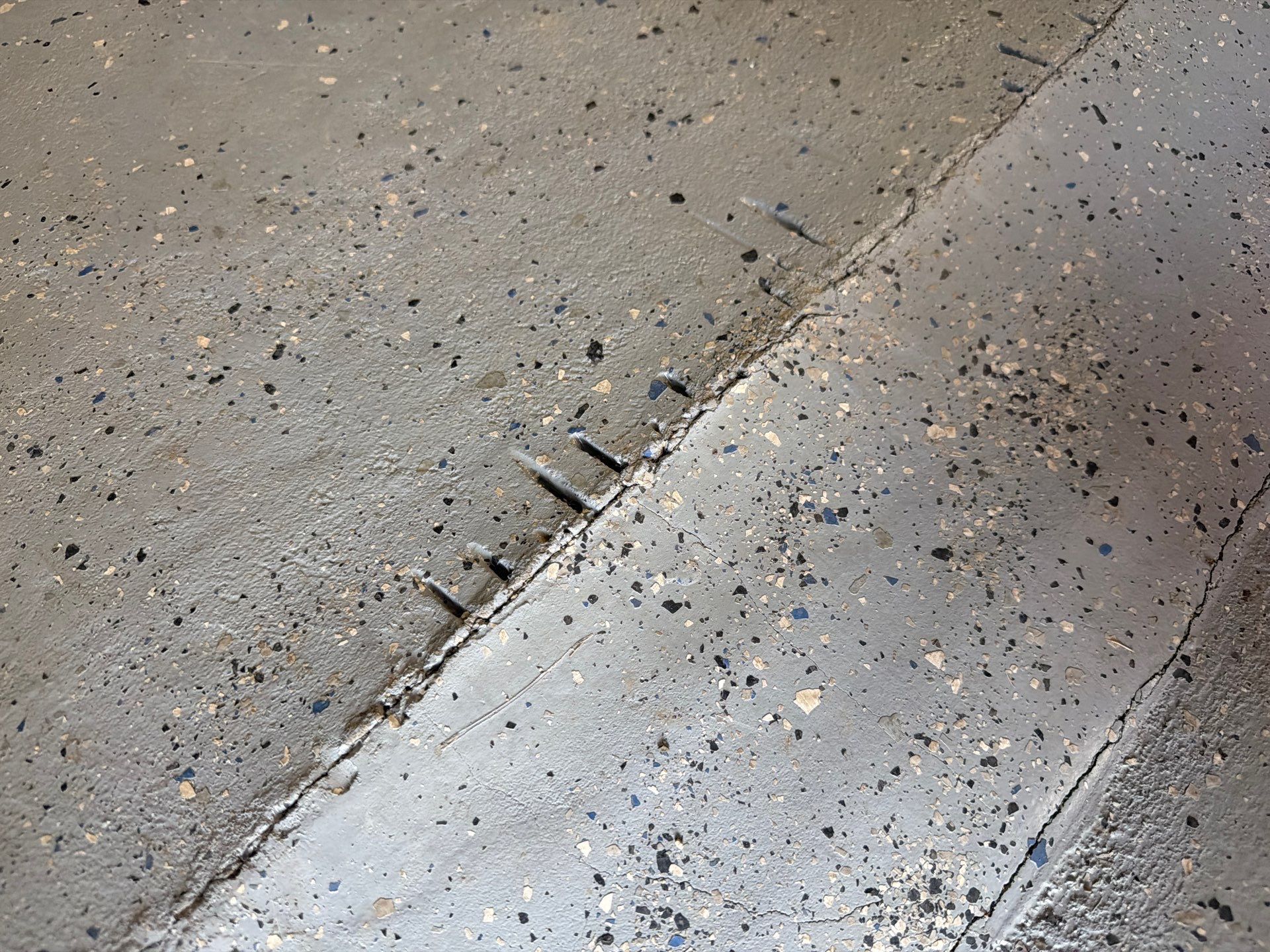 Custom Grey Flake Epoxy Garage Floor Installation in Remsen by Select Painting, Coatings & Garage Cabinets