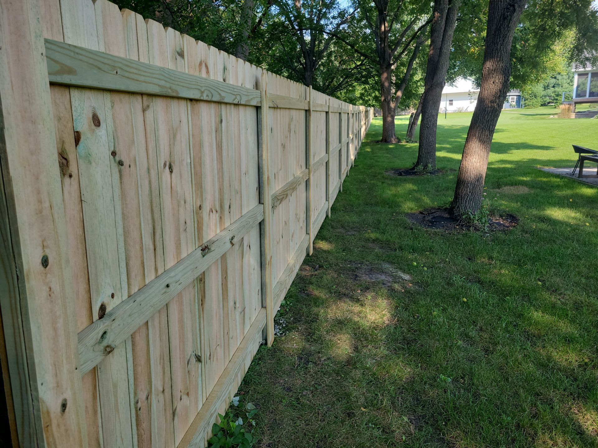 Pressure-Treated Wood Privacy Fence Replacement in Cedar Falls by Perfect Picket Fence and Stain