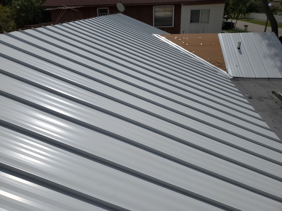 Residential Roofing Installation using 1.5" Nail Strip 24ga Solar White Kynar Coated Standing Seam Metal Panels by Morton Roofing, Inc.