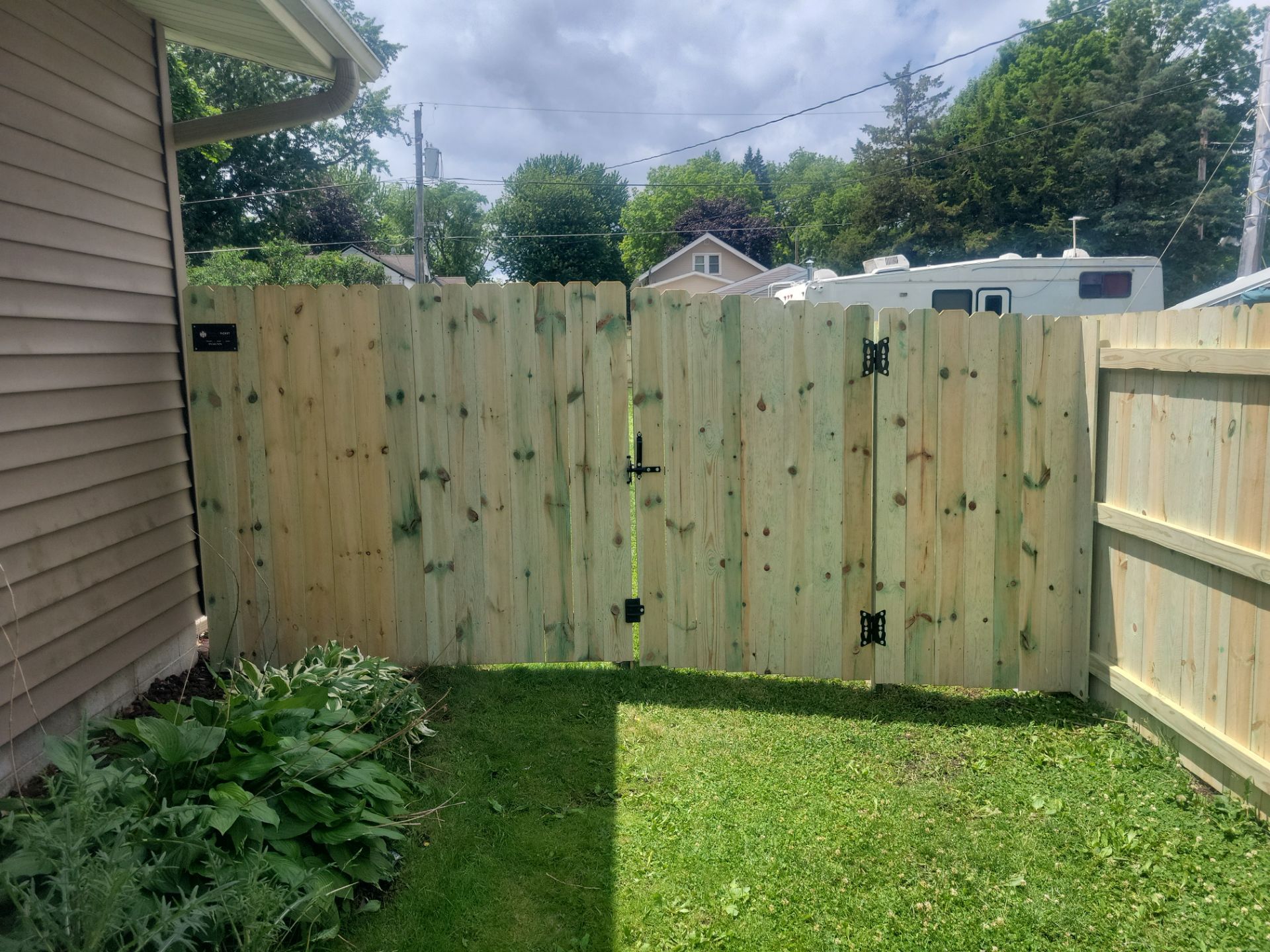 Pressure-Treated Wood Privacy Fence Installation in Charles City by Perfect Picket Fence and Stain