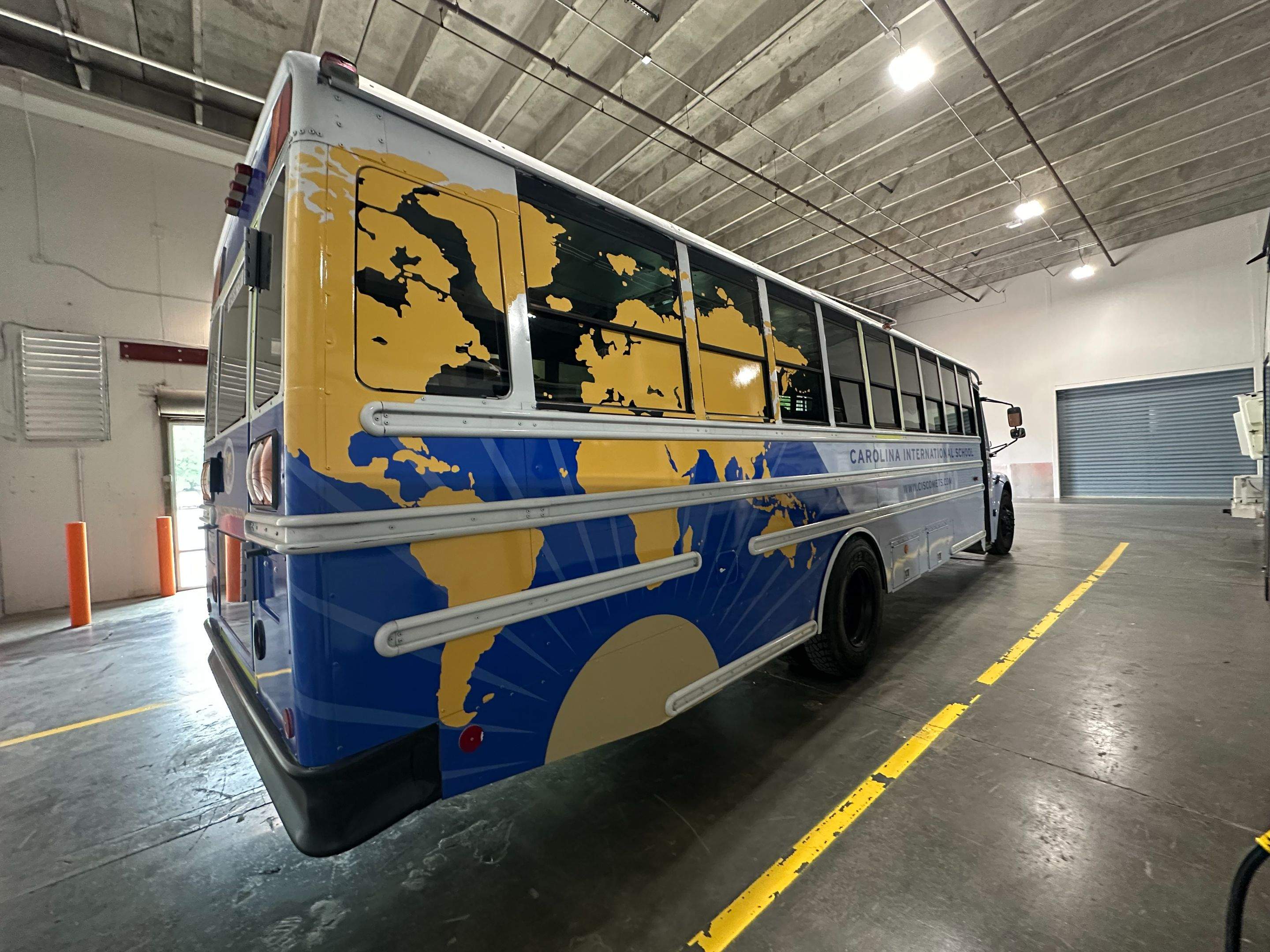 Carolina International School - Bus Vinyl Wrap by QC Signs and Graphics