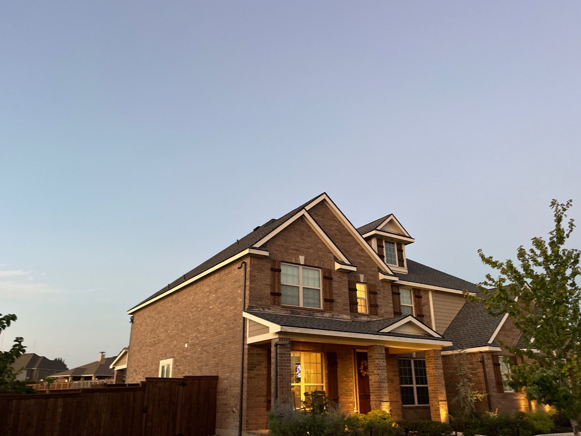 Medium brown brick with GAF Pewter Gray  by Tejas Roofworks + Restoration