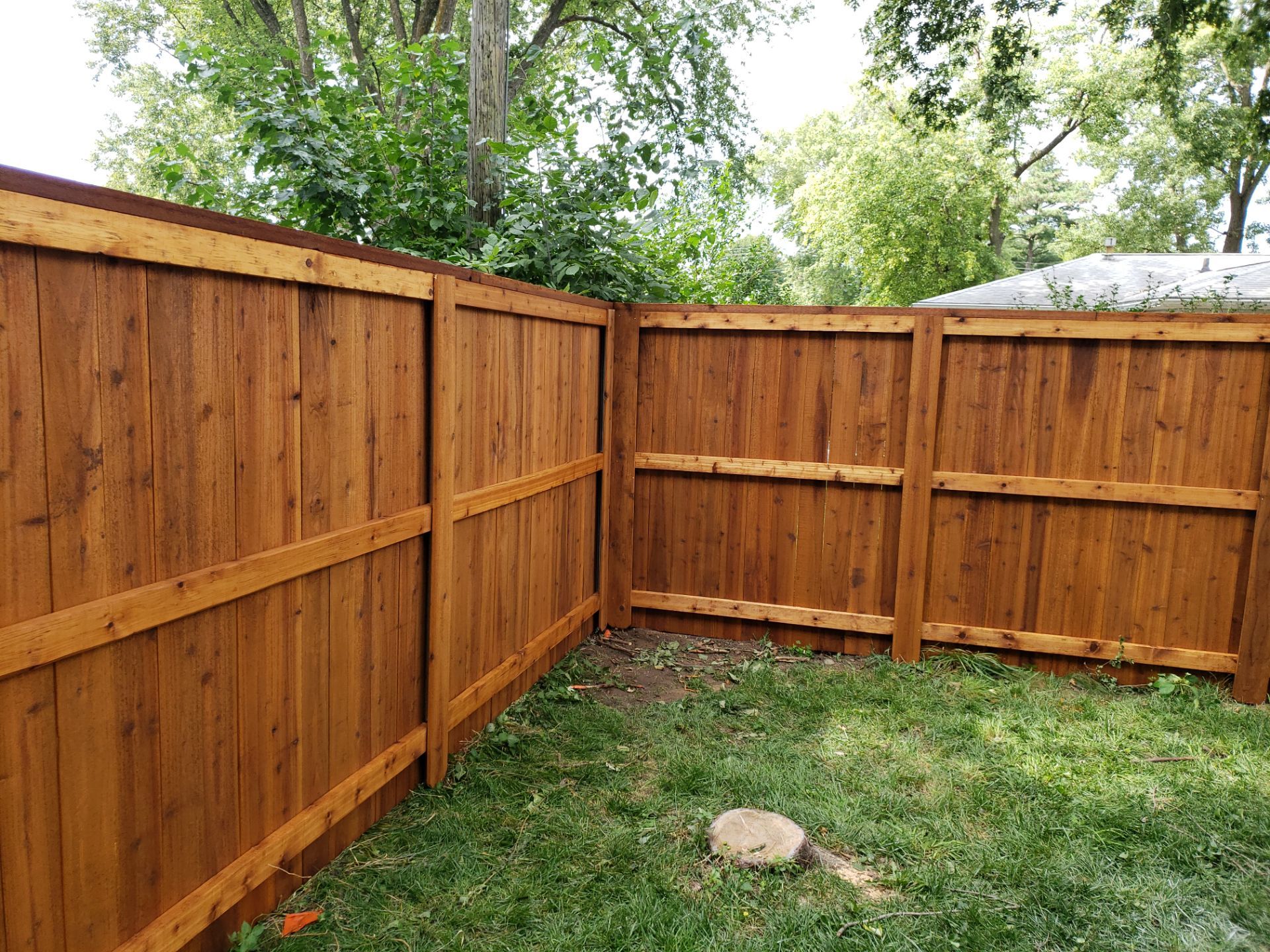 Custom Cedar Privacy Fence with Decorative Gate Windows in Cedar Falls by Perfect Picket Fence and Stain