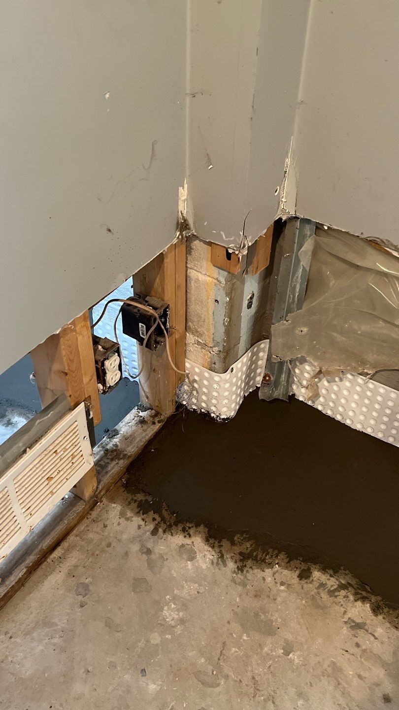 Interior drain tile system installation by ACE Waterproofing & Basement Solutions