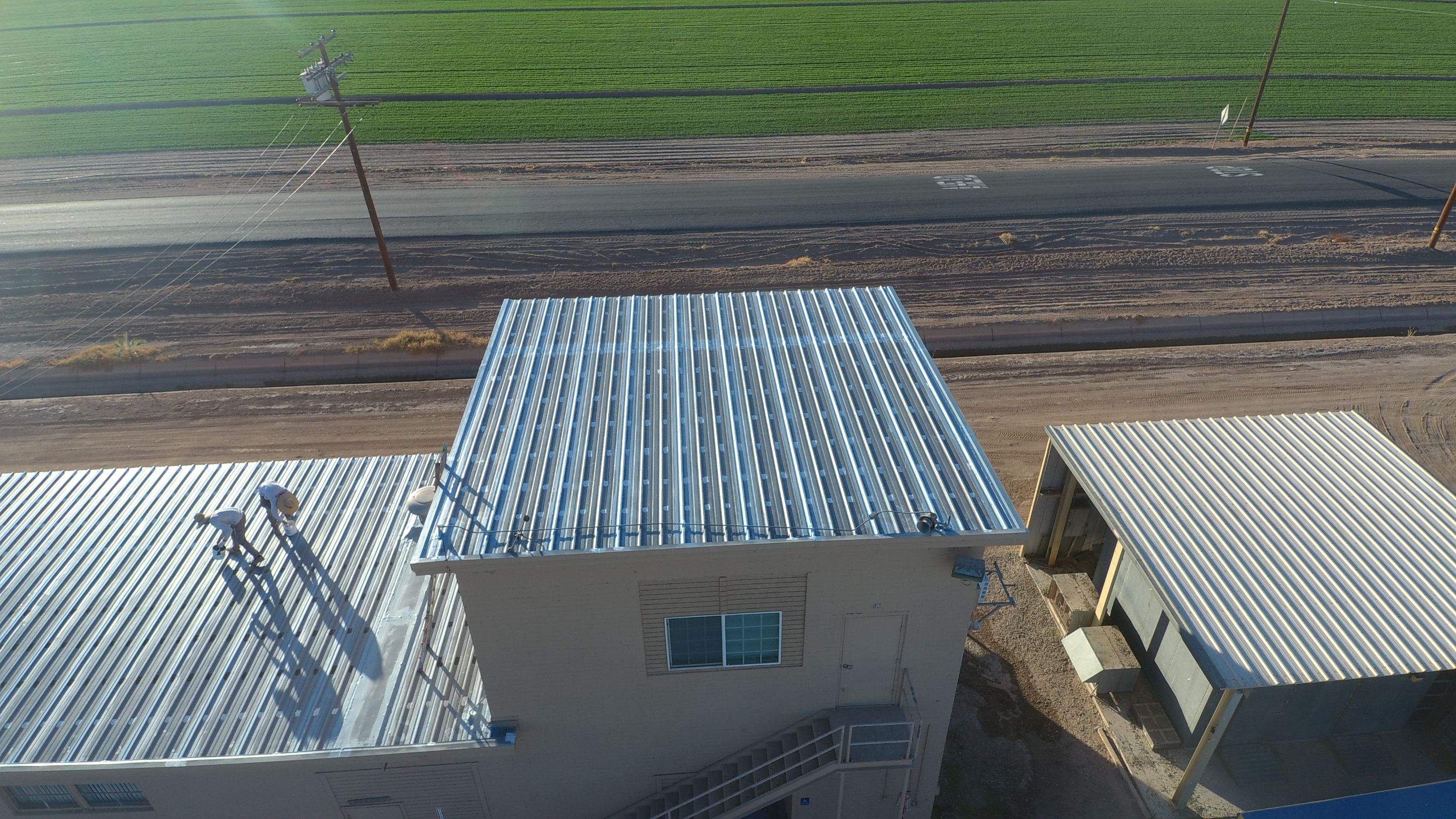 Metal roof restoration on commercial roof using Conklin Benchmark/PUMA XL fabric and coating by Straight Edge Roofing Inc