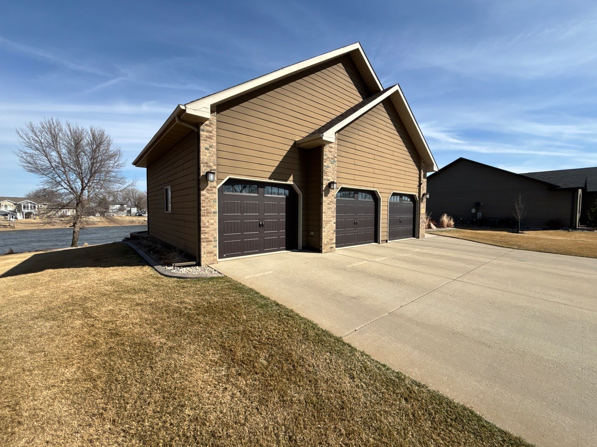 Full Exterior Renovation with Stone Veneer and Composite Decking by Select Painting, Coatings & Garage Cabinets