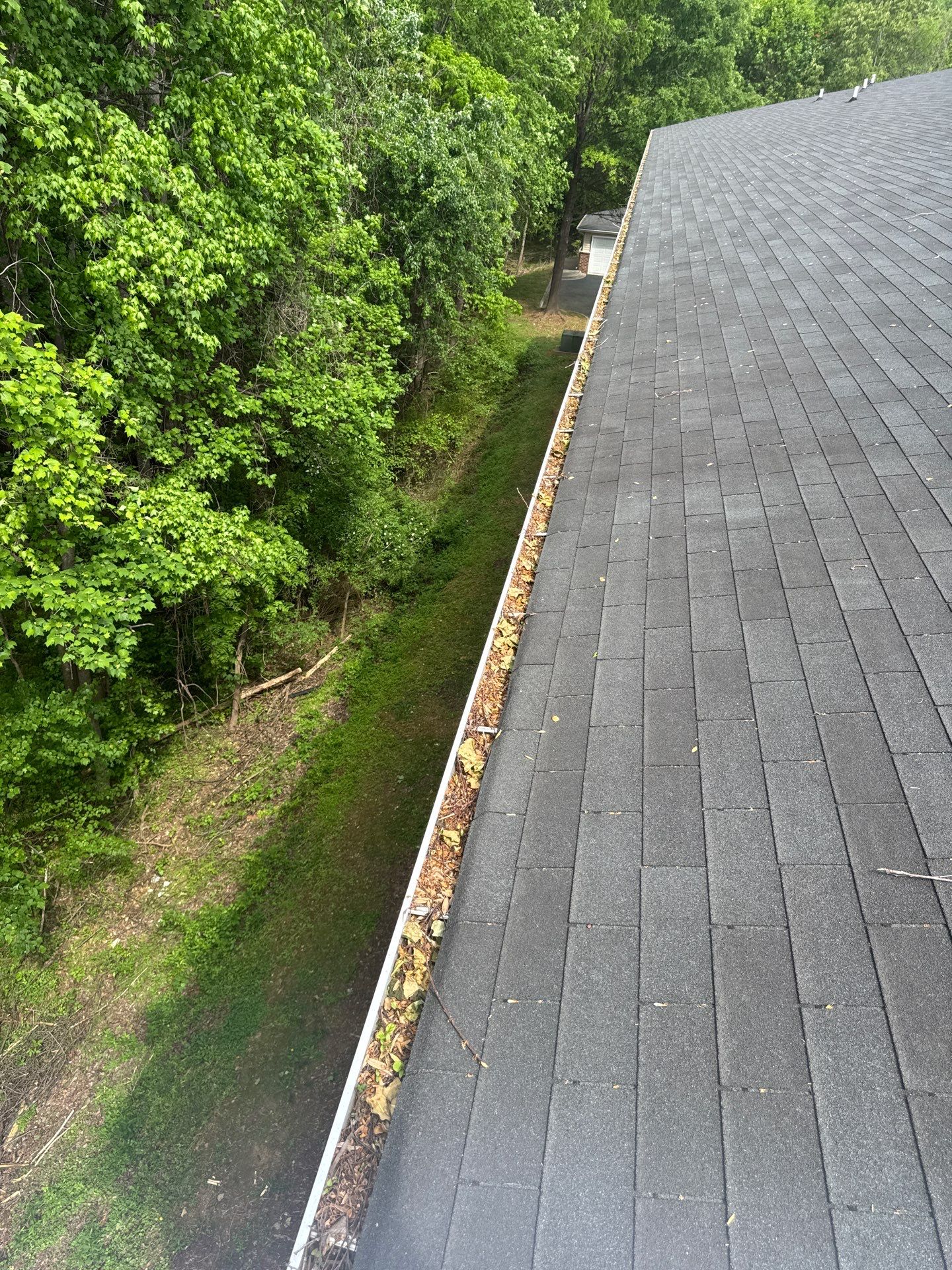 Commercial gutter cleaning Burlington & Mebane, NC before photo with filled gutters
