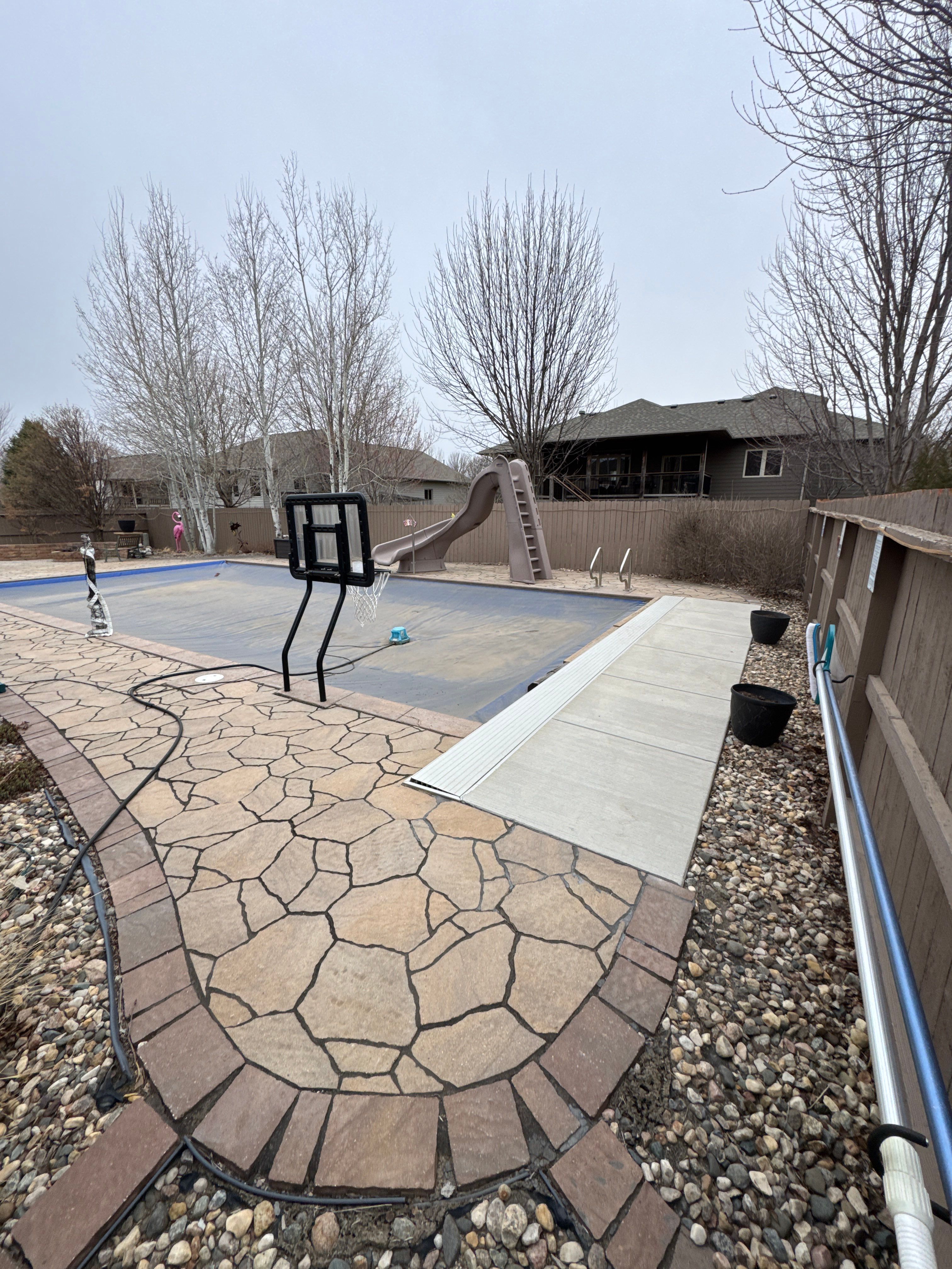 Sioux Falls Residential Exterior Update and Flagstone Pool Deck by Select Painting, Coatings & Garage Cabinets