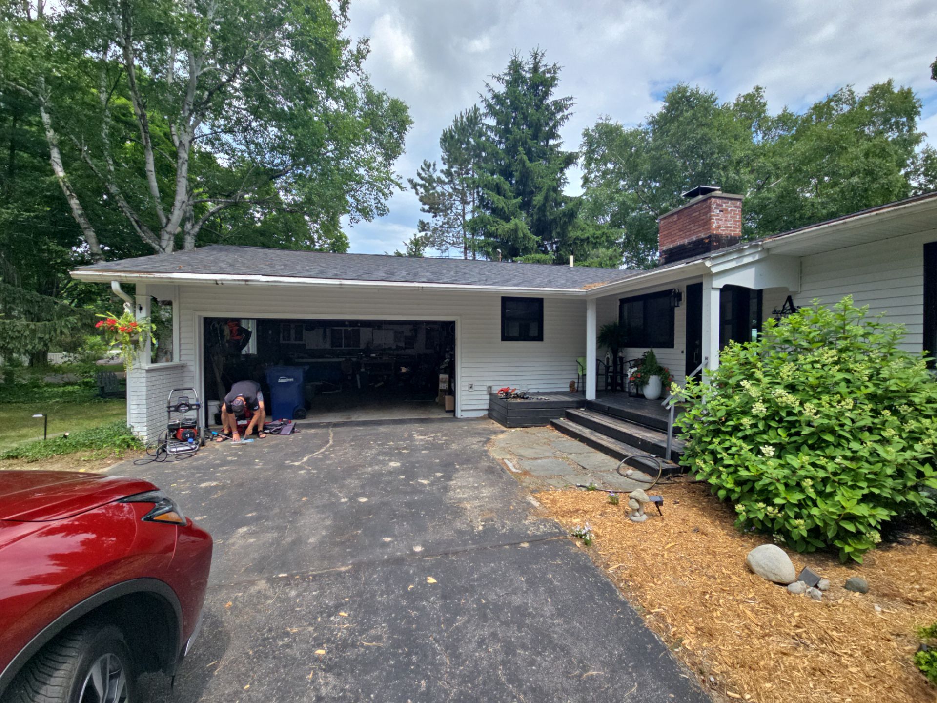 Black Gutter and Gutter Helmet Installation for Suttons Bay Home by Rainbow Seamless Systems