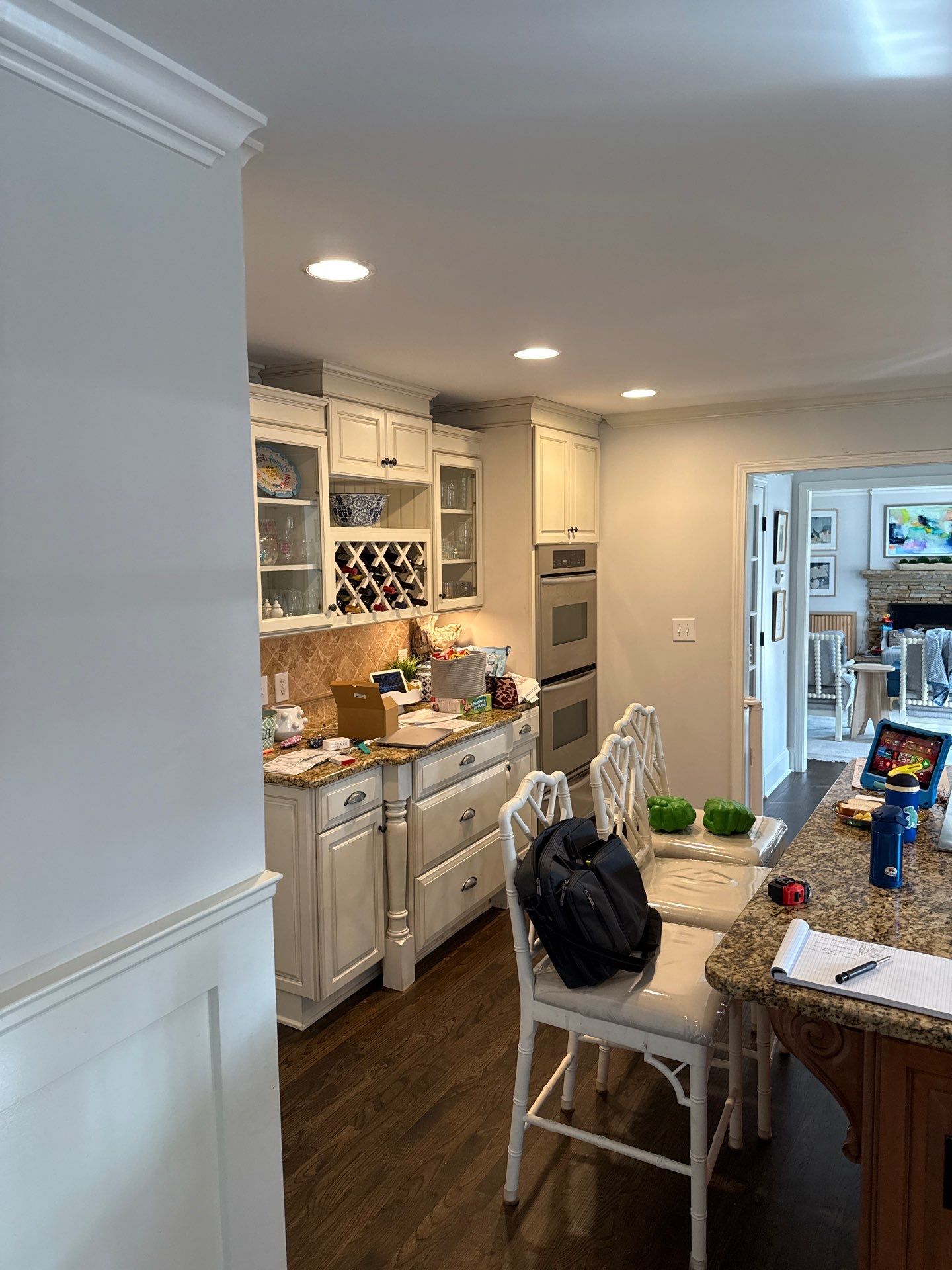 Kitchen Remodel in Dunwoody Featuring White Cabinetry and Blue Island by Heart & Home Kitchen & Bath Remodeling LLC