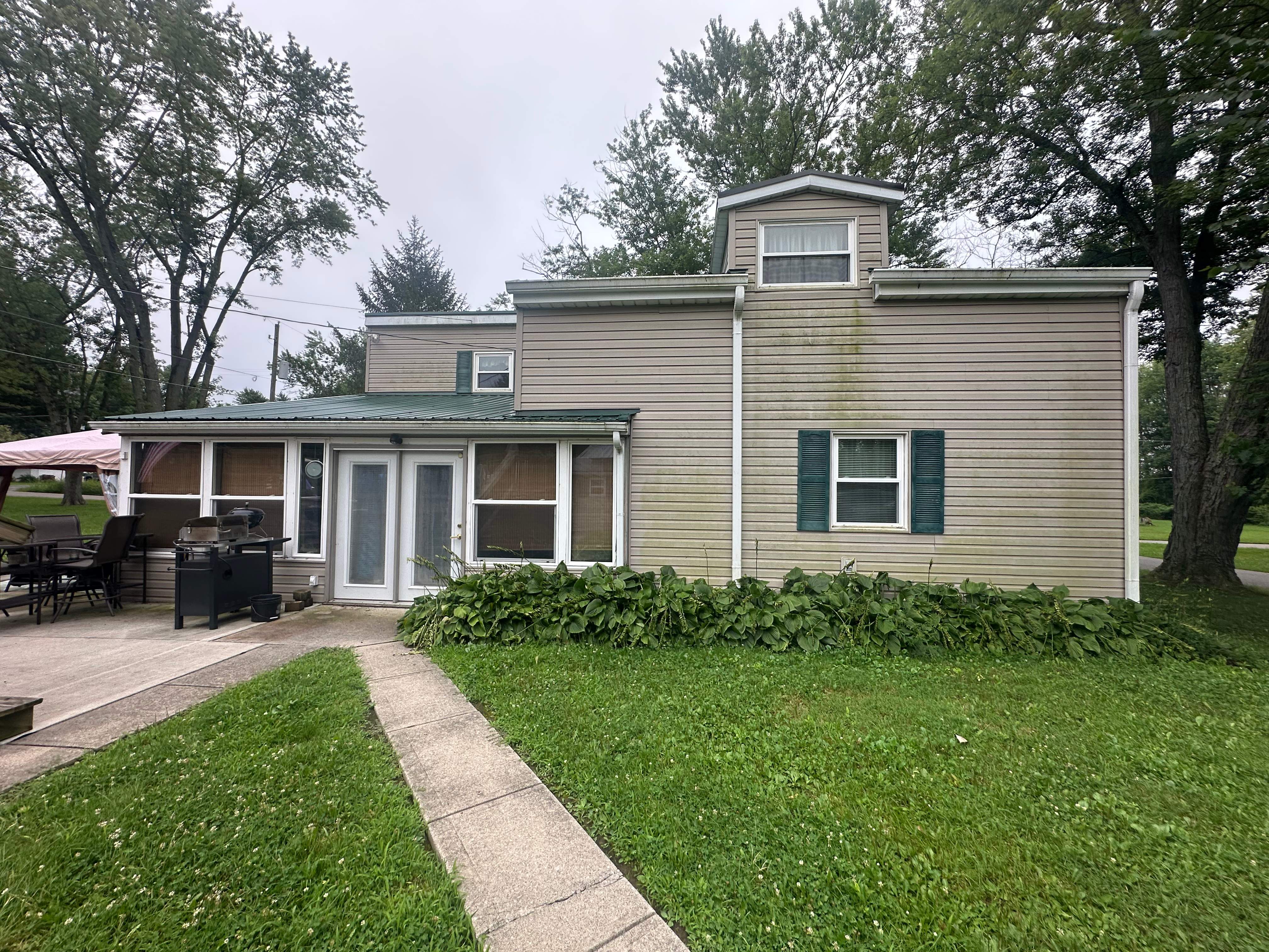 Green Metal Roof Installation and Exterior Renovation in Thornville by Canopy Contracting