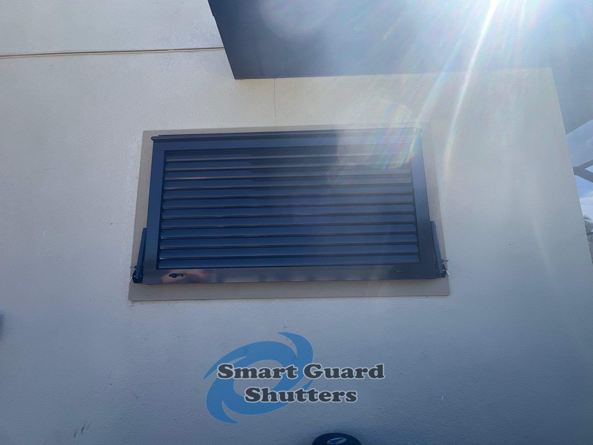 Impact Bahama Shutter in Grey Brown by Smart Guard Shutters