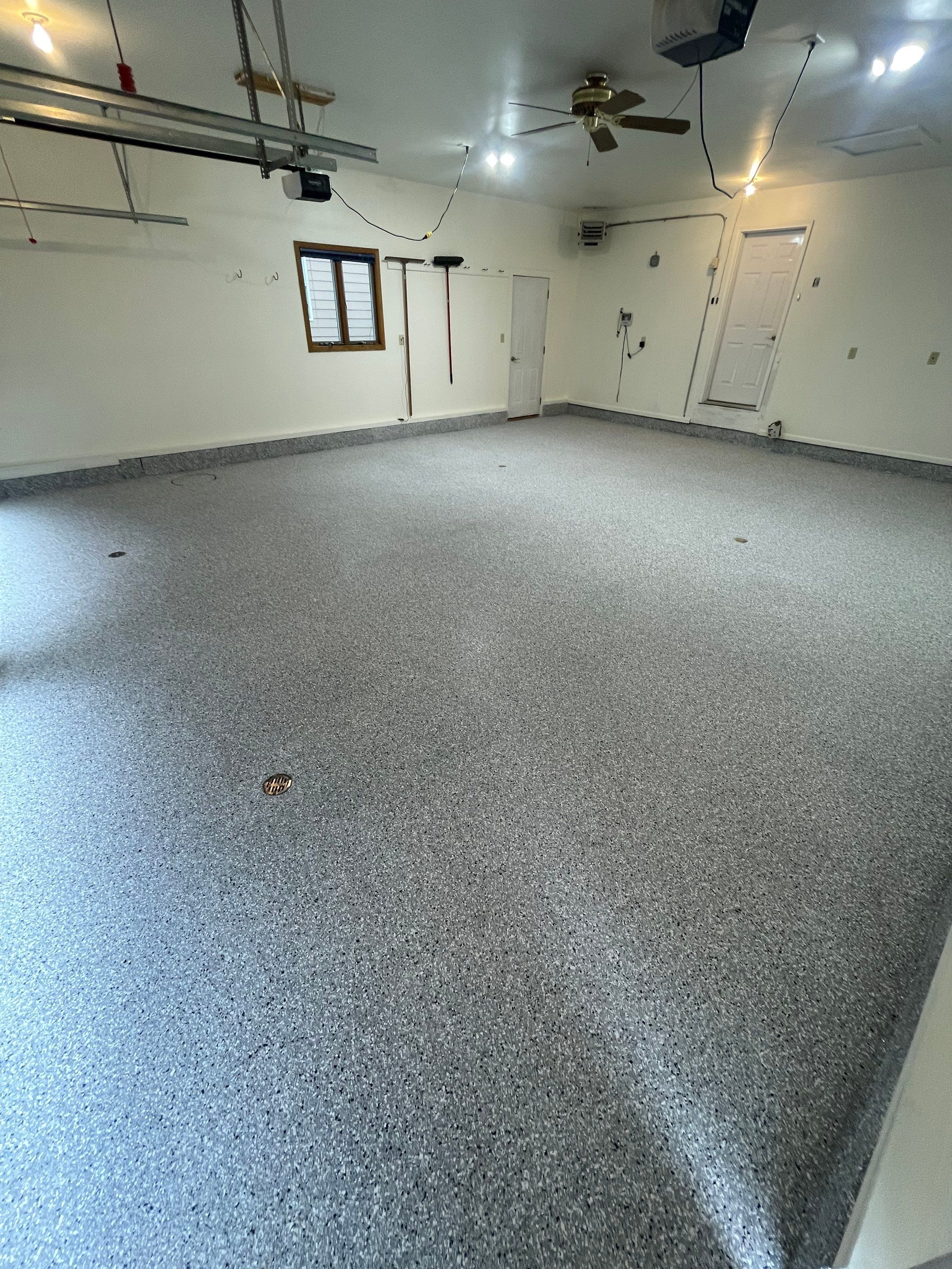 Madison Garage Concrete Coating with Feather Grey Speckle Finish by Select Painting, Coatings & Garage Cabinets