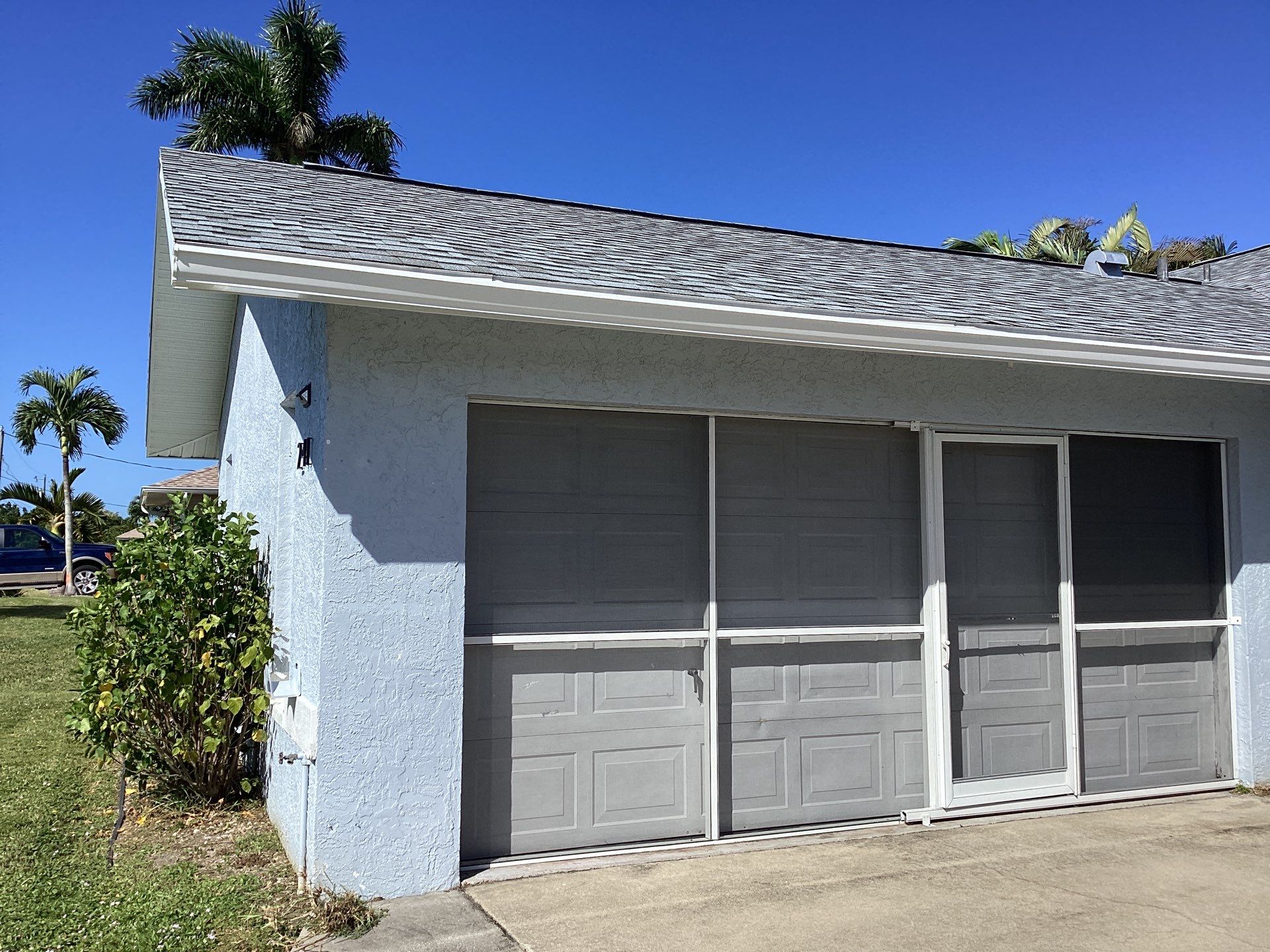 New White Seamless Gutters with Downspouts and Splash Guards in Cape Coral FL by Gutter Professors