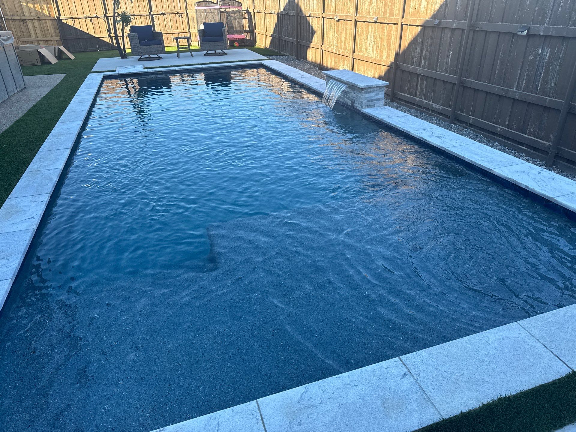 Pool with Turf and Raised Wall by Pinnacle Pools and Spas - DFW