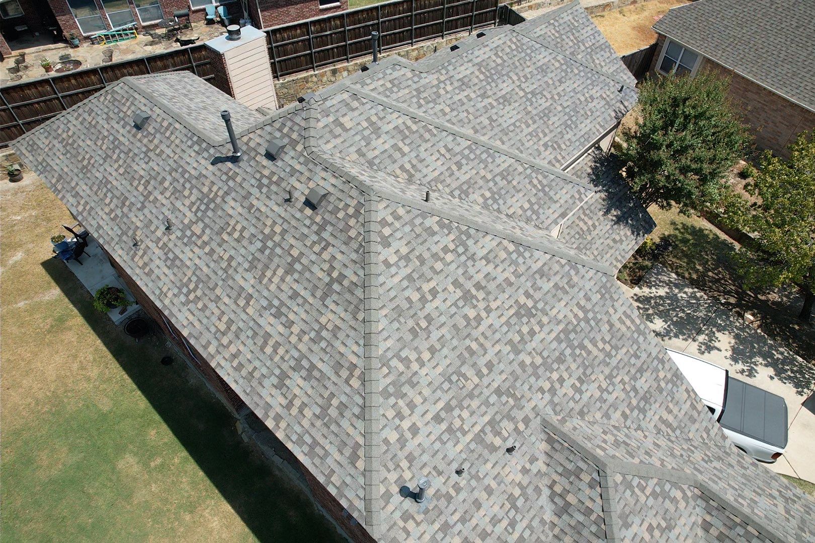 Red brick/white stone with IKO Cornerstone by Tejas Roofworks + Restoration