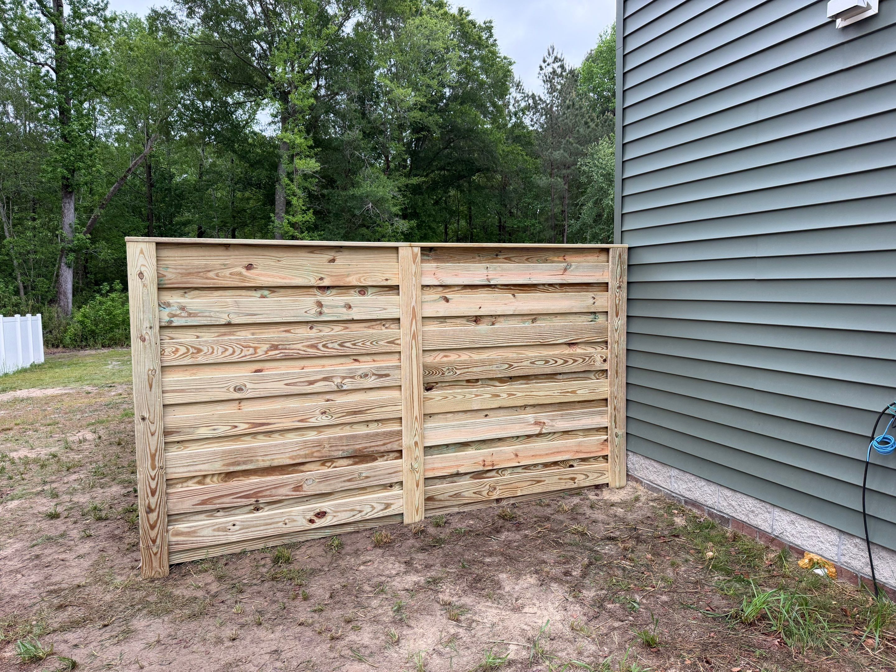 Modern Horizontal Wood Privacy Fence and Backyard Patio in Greenville by Superior Fence and Rail