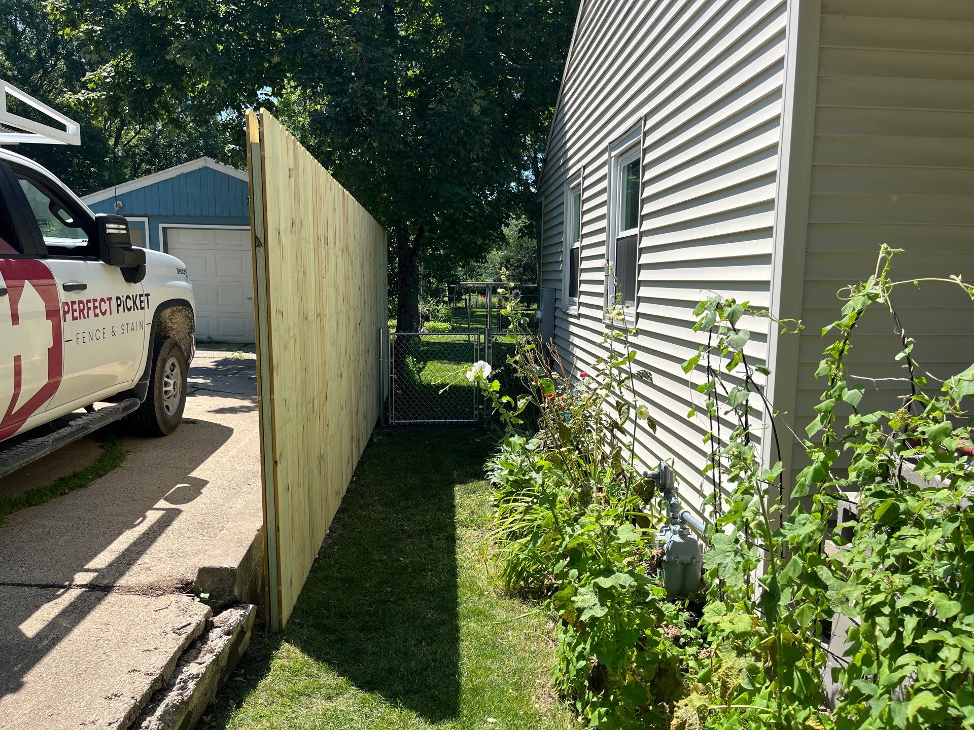 Pressure-Treated Wood Privacy Fence Installation in Cedar Falls by Perfect Picket Fence and Stain