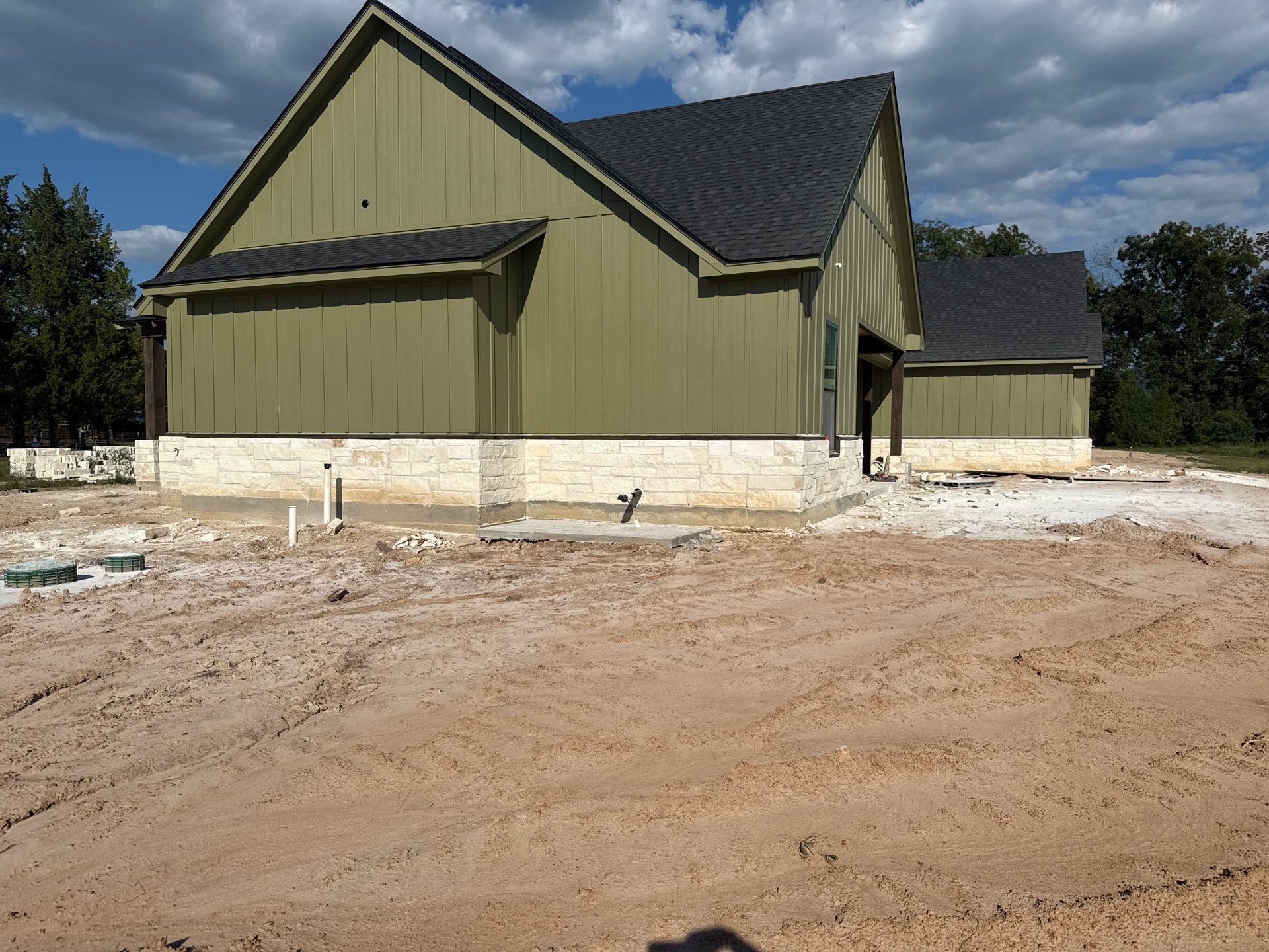 Cleveland Ranch Charm: Natural Stone Wainscot with Green Accent Siding. by Apex Conventional Stucco Llc