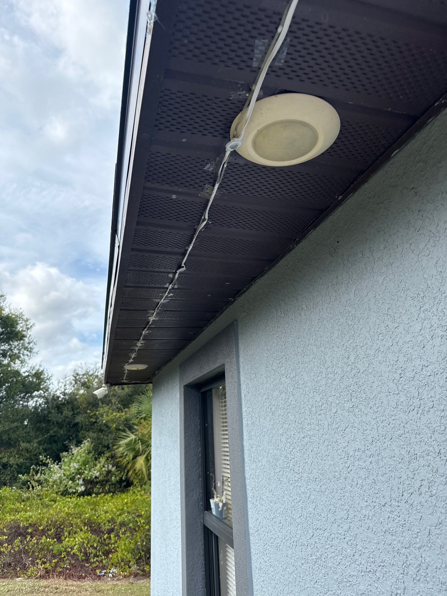 Black Seamless Gutters & Soffit/Fascia in Lehigh Acres FL by Gutter Professors