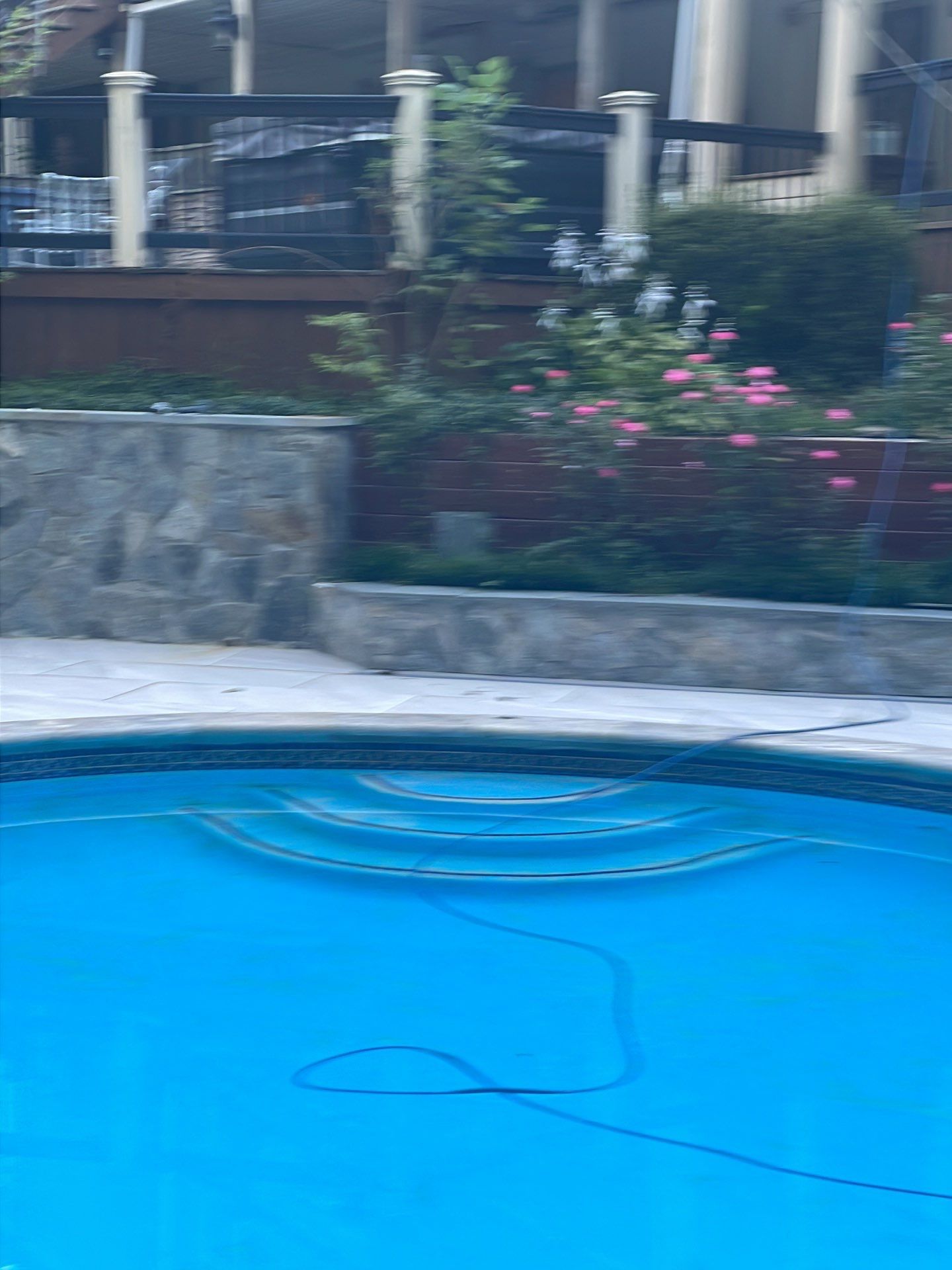 Pool Surround remodel with retaining walls, new waterfall and water slide by Fairfax Contractors, LLC