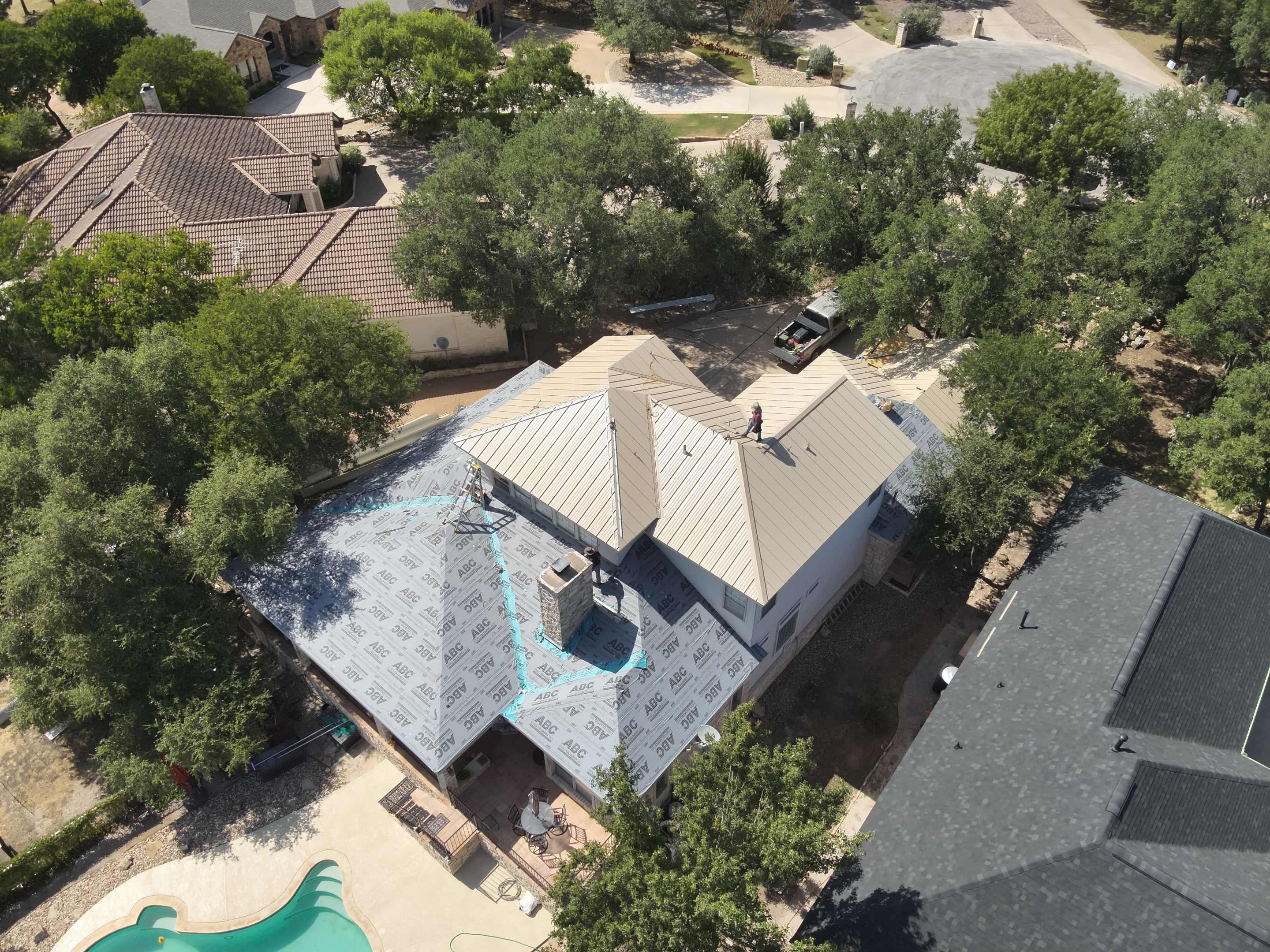 Residential Roof Replacement using 24 GA Double-Lock - Surrey Beige by Action Exteriors Austin