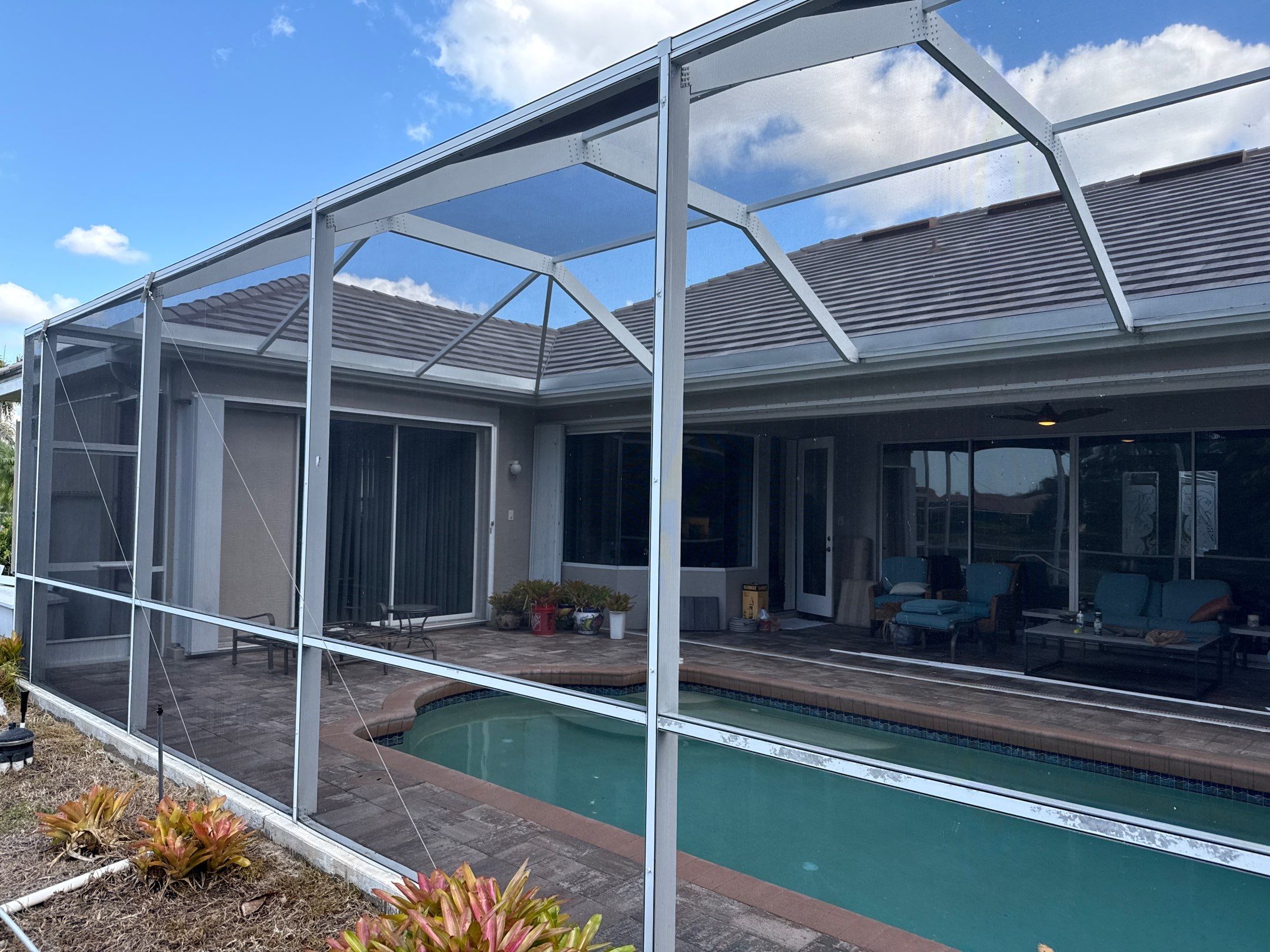Paver Pool Deck & Screen Enclosure Transformation | University Park, Sarasota FL by Sunshine AquaWash