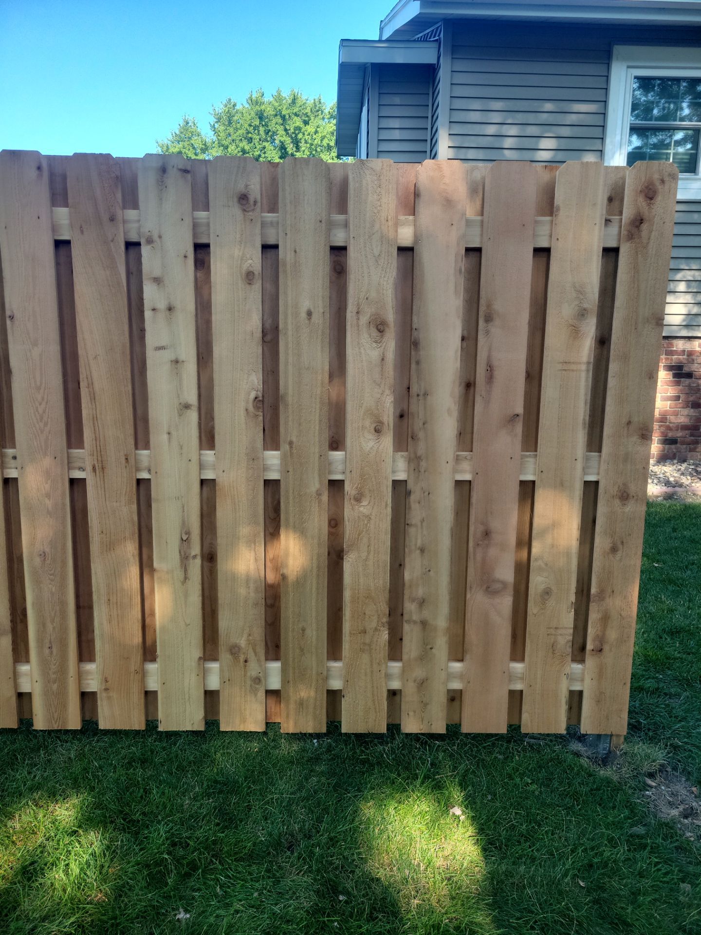 Unstained Cedar Wood Privacy Fence Installation in Cedar Falls by Perfect Picket Fence and Stain