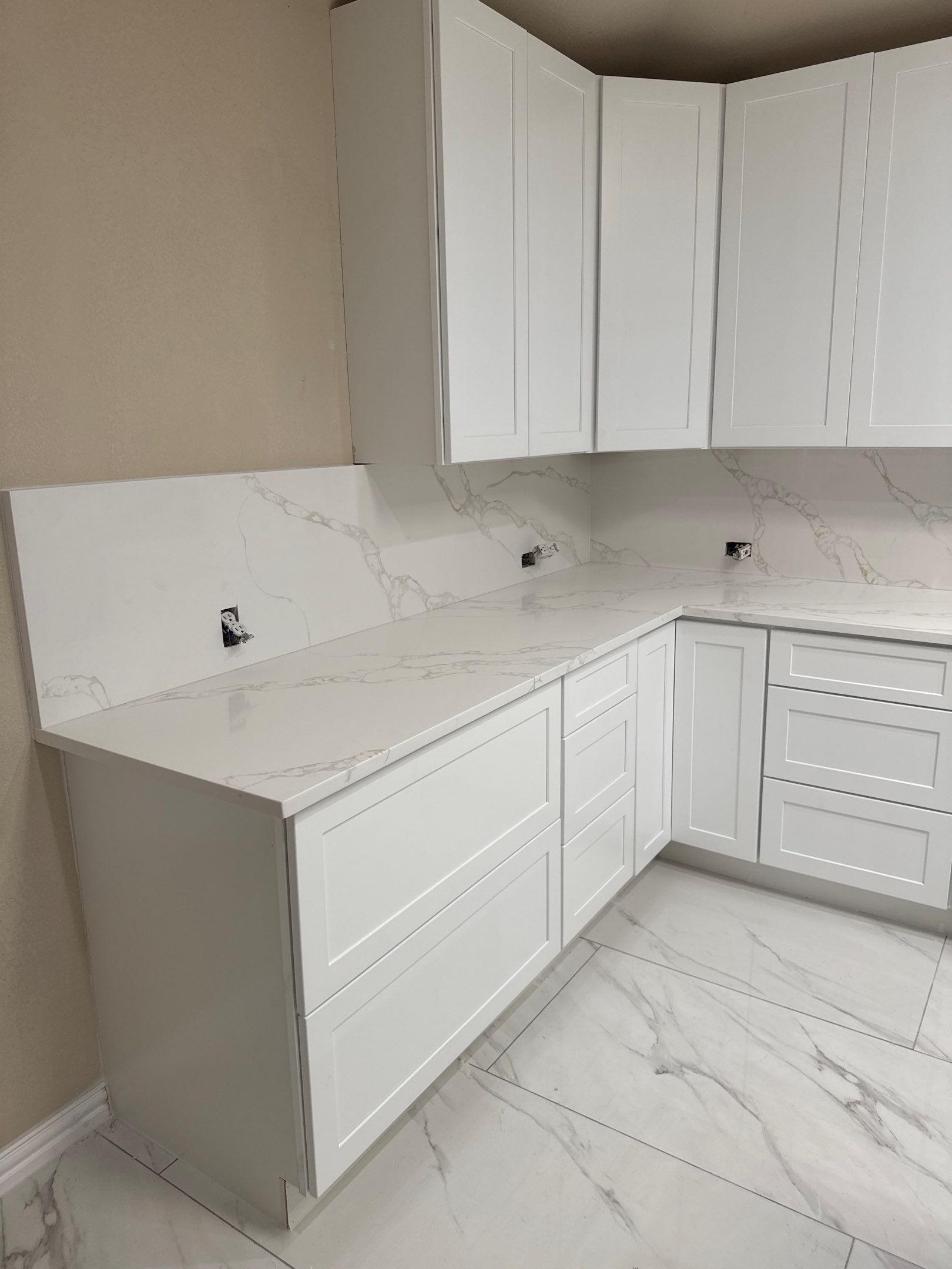 Luxury Focal Point: Full Kitchen Remodel with Double Waterfall Island by Tibi Soli LLC