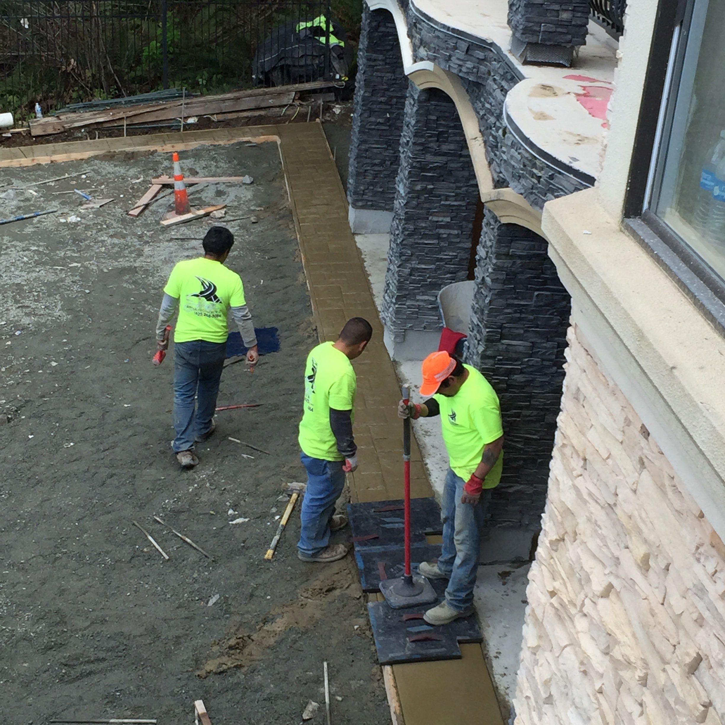 Asphalt Driveway and Stamped Concrete Patio Finish  by Jireh Asphalt & Concrete Inc 